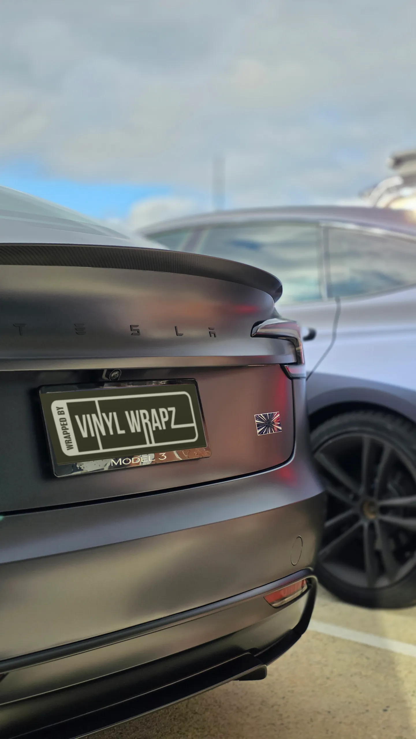Tesla lettering and black spoiler on the satin grey Model 3 boot lid