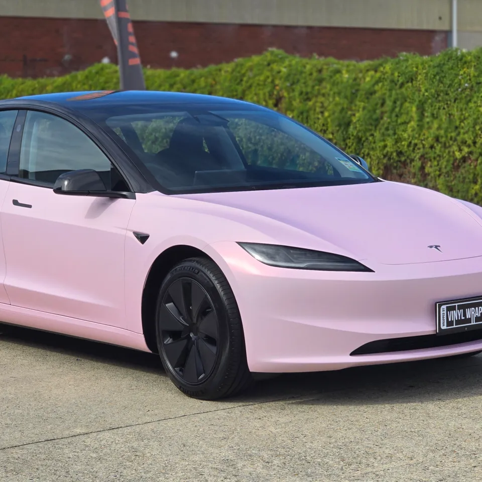 Pale pink satin Tesla Model 3 with black roof and wheels, front quarter