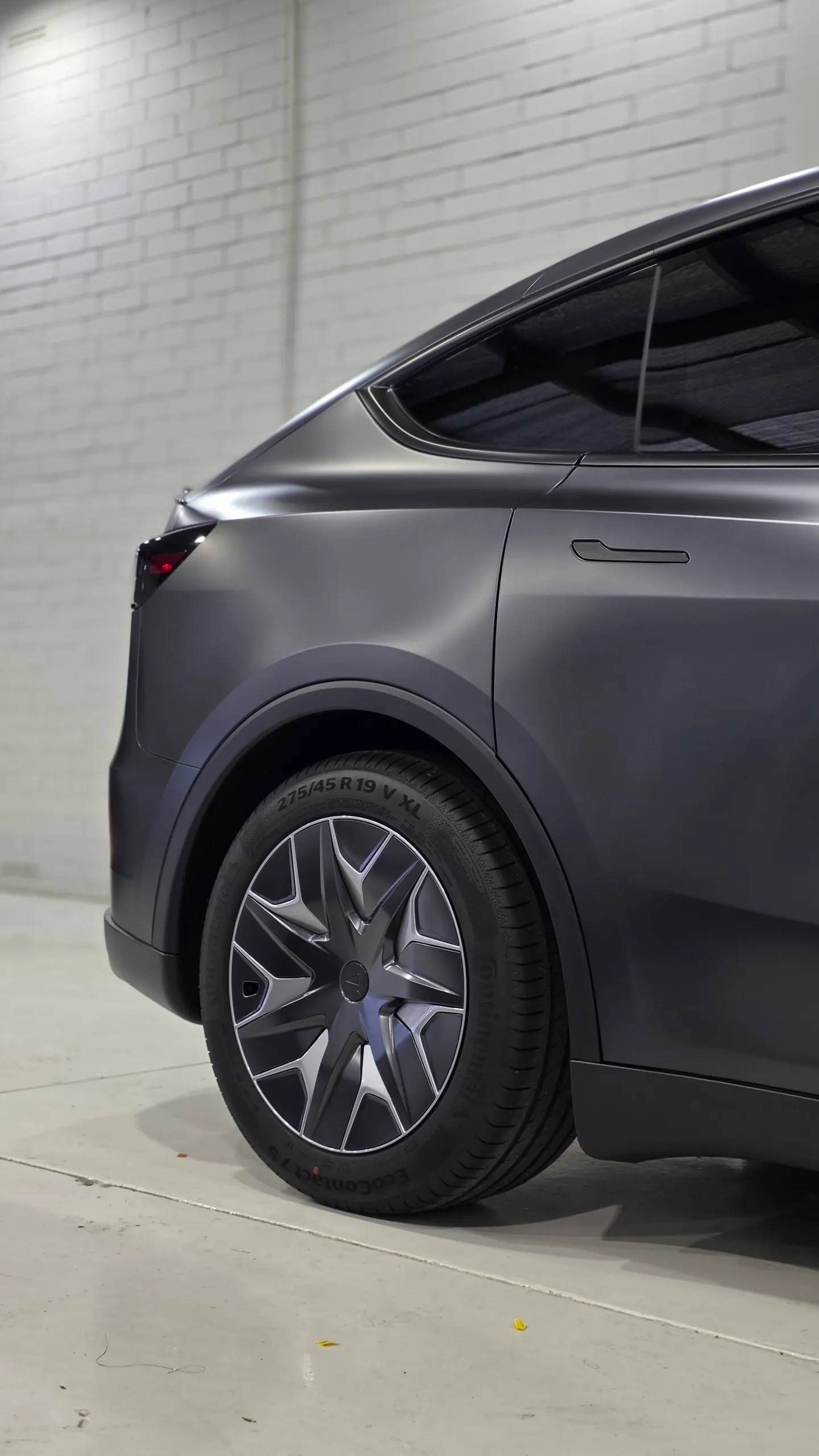 Tesla Model Y rear wheel, matte dark grey quarter panel and rear door