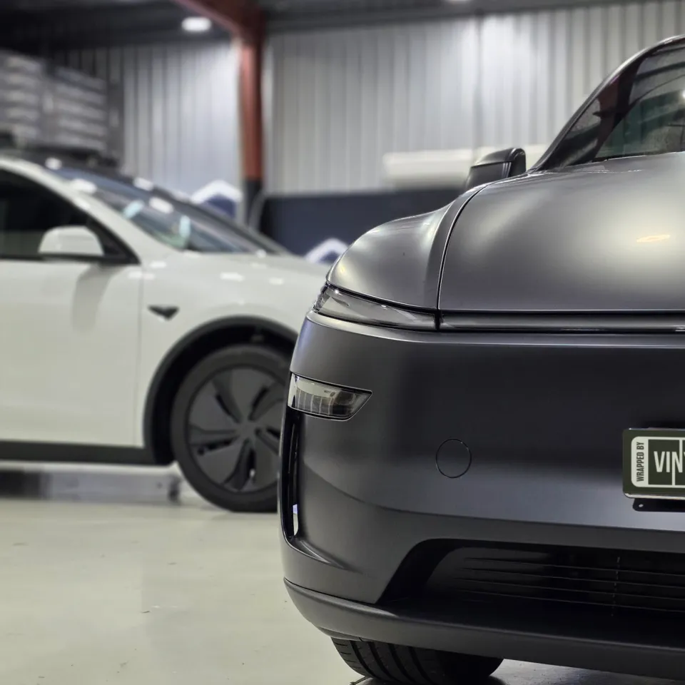 Matte dark grey Tesla Model Y front bumper and bonnet edge in the workshop