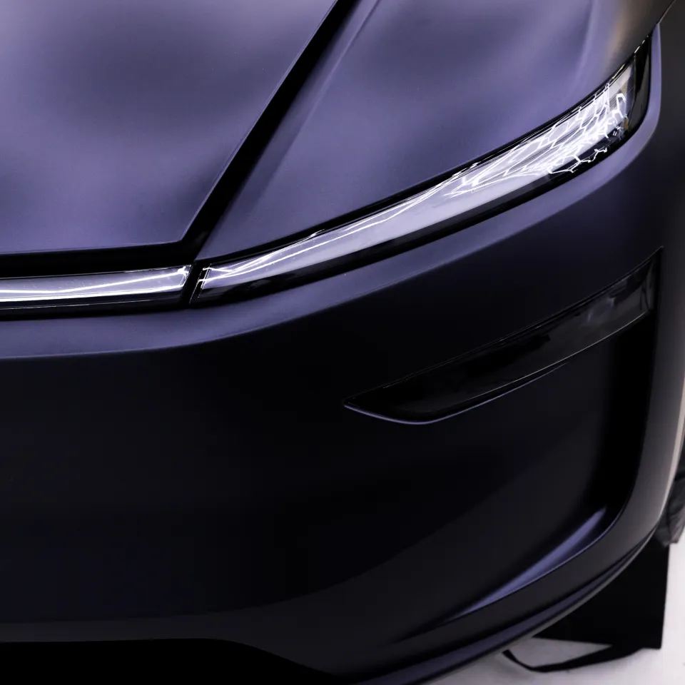 Satin finish around the Tesla Model Y front light bar and bumper