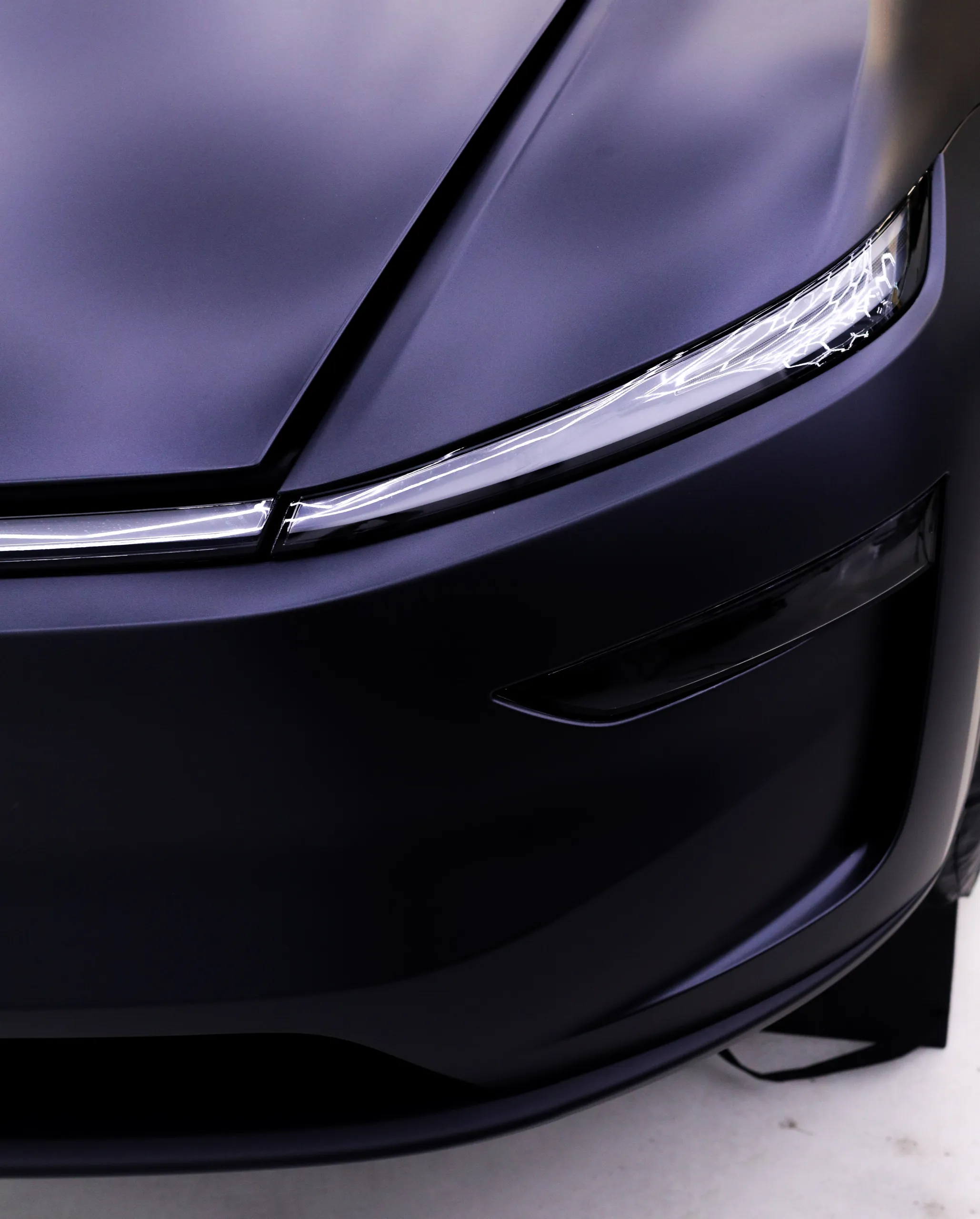 Satin finish around the Tesla Model Y front light bar and bumper