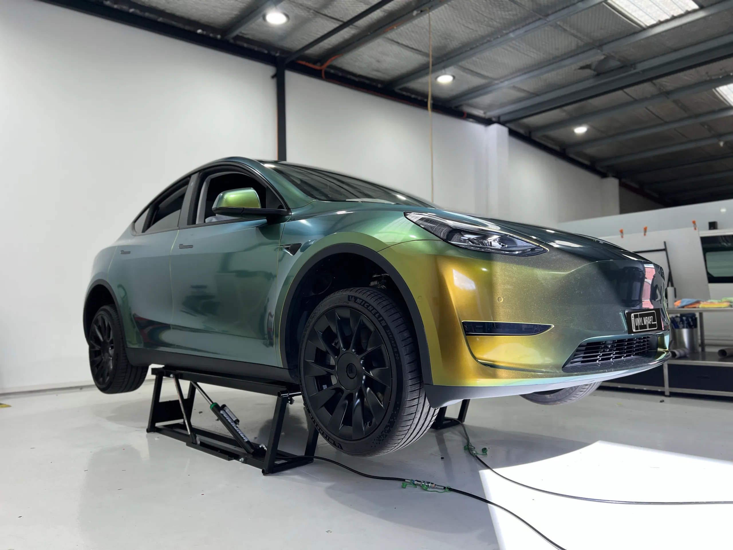 Golden green colour-shift Tesla Model Y, front quarter