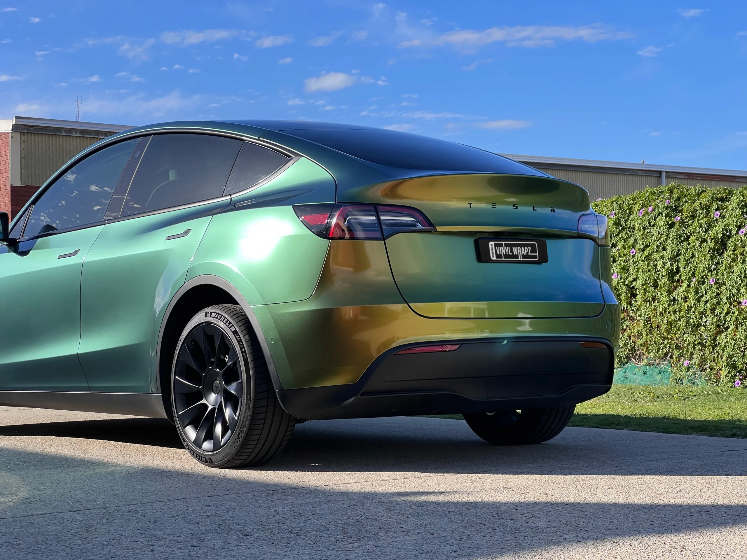 Golden green colour-shift Tesla Model Y, rear quarter