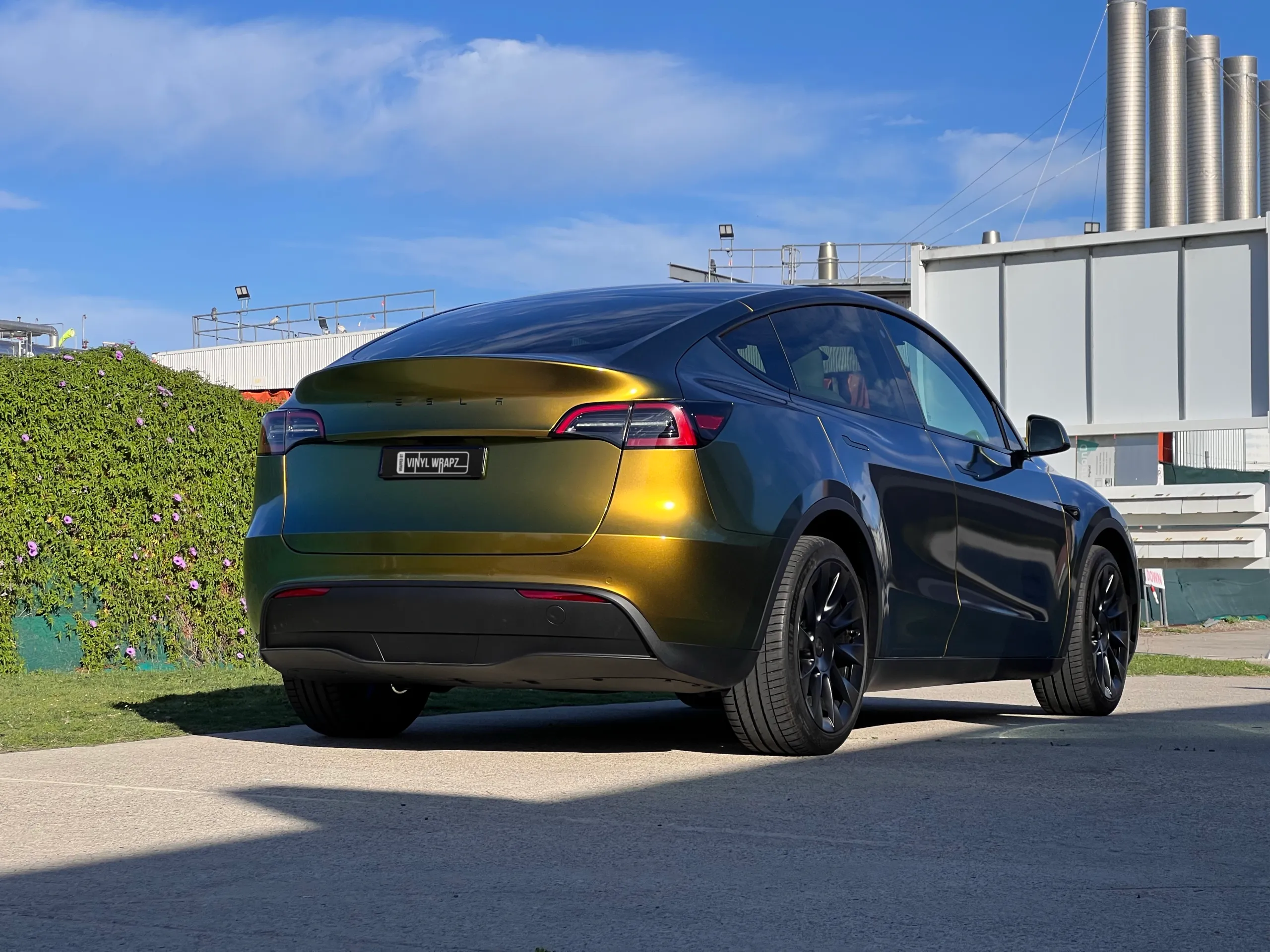 Golden green colour-shift Tesla Model Y, rear quarter