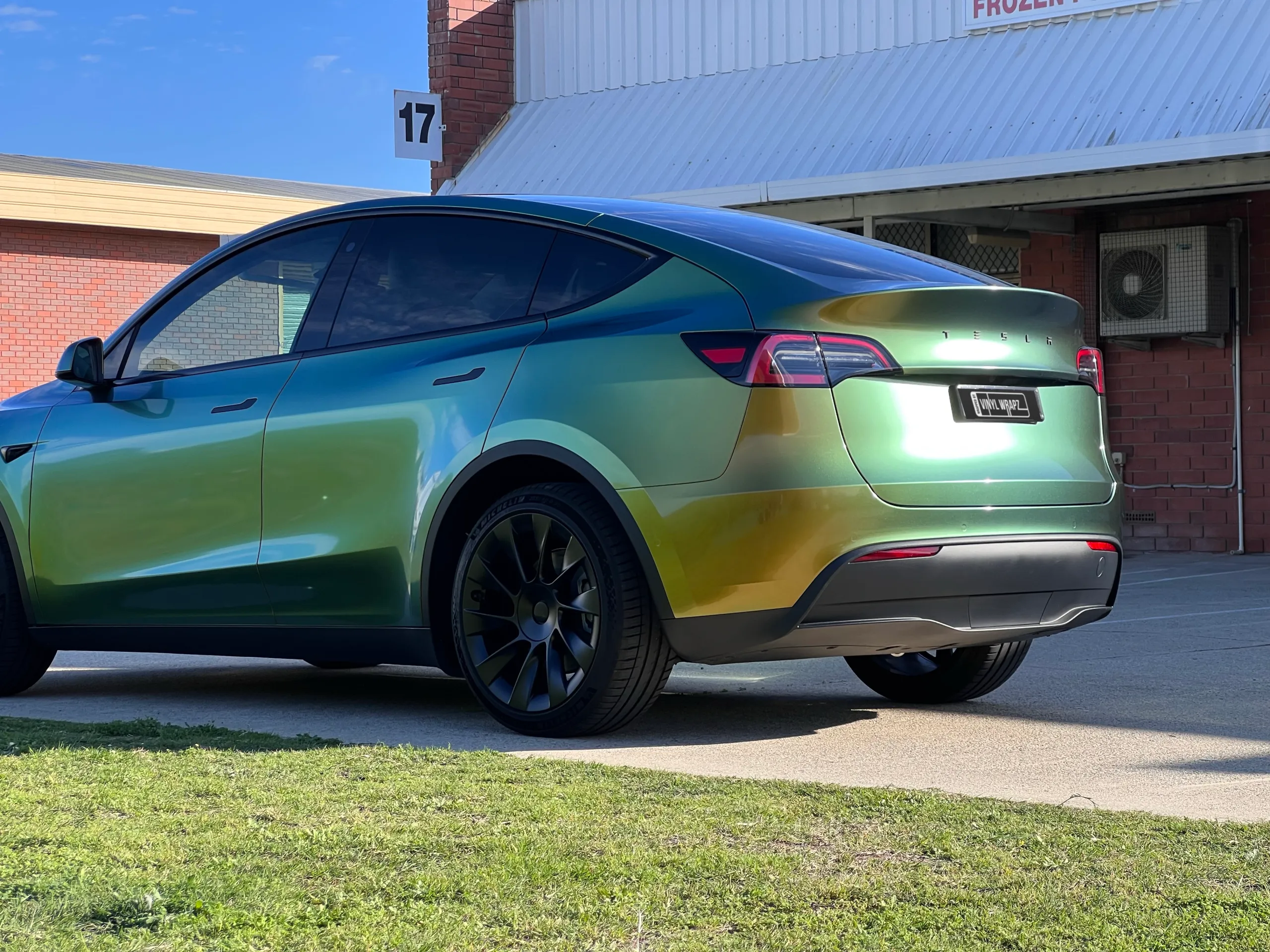 Golden green colour-shift Tesla Model Y, rear quarter