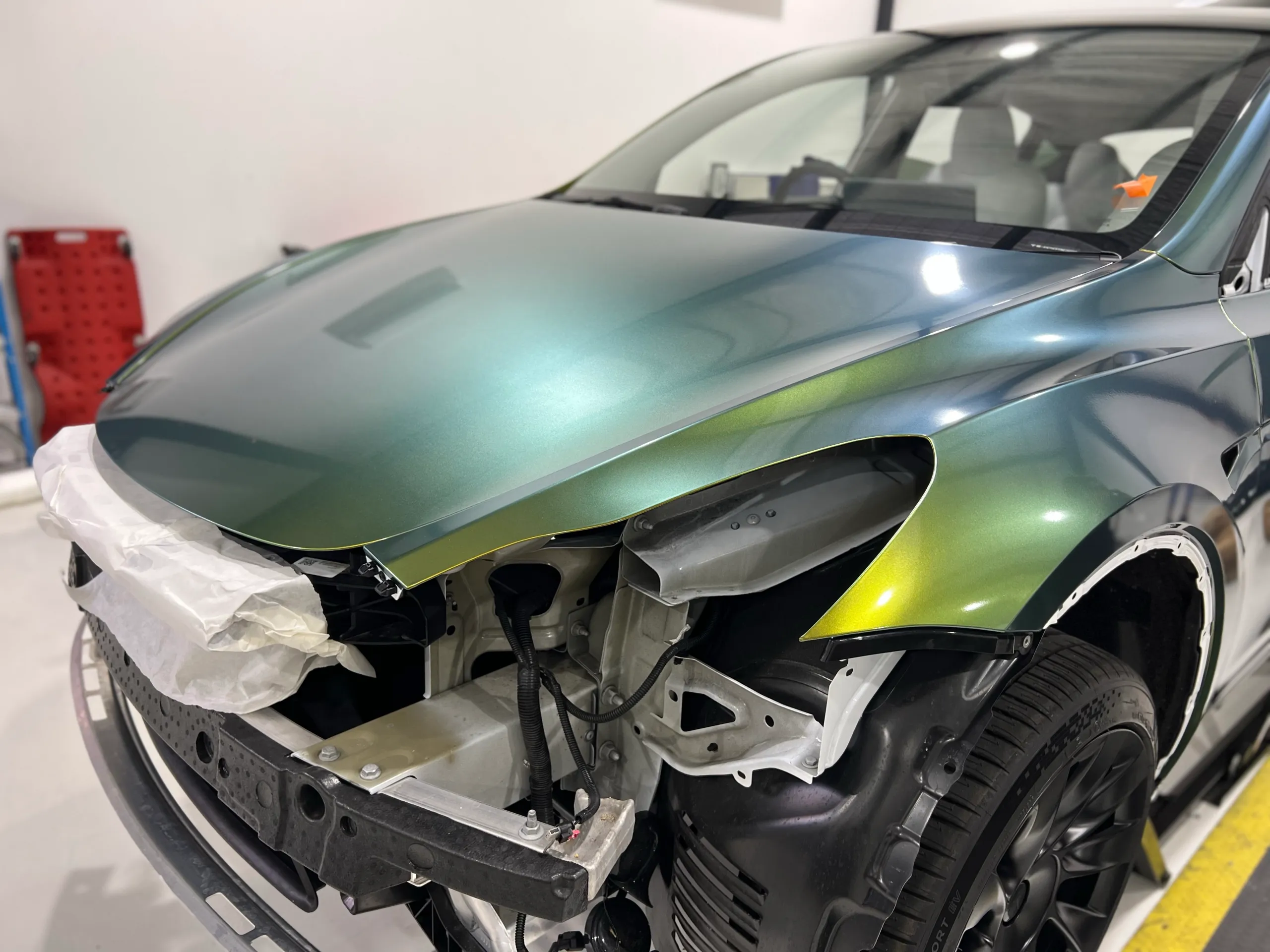 Golden green colour-shift Tesla Model Y, front quarter