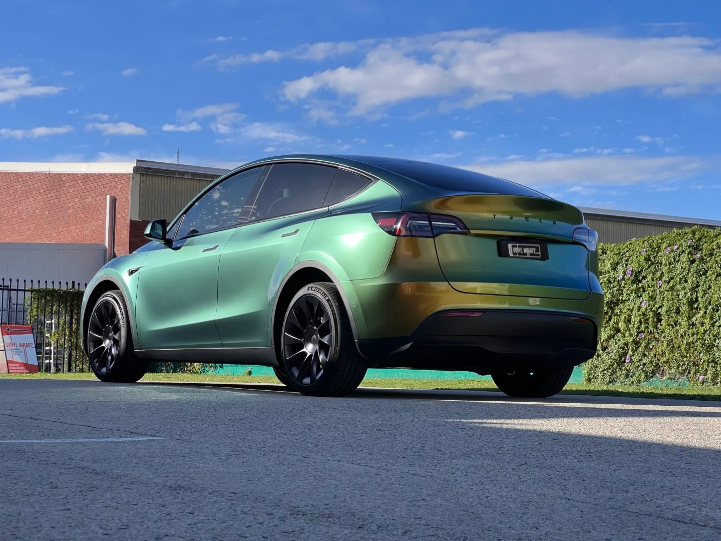 Golden green colour-shift Tesla Model Y, rear quarter