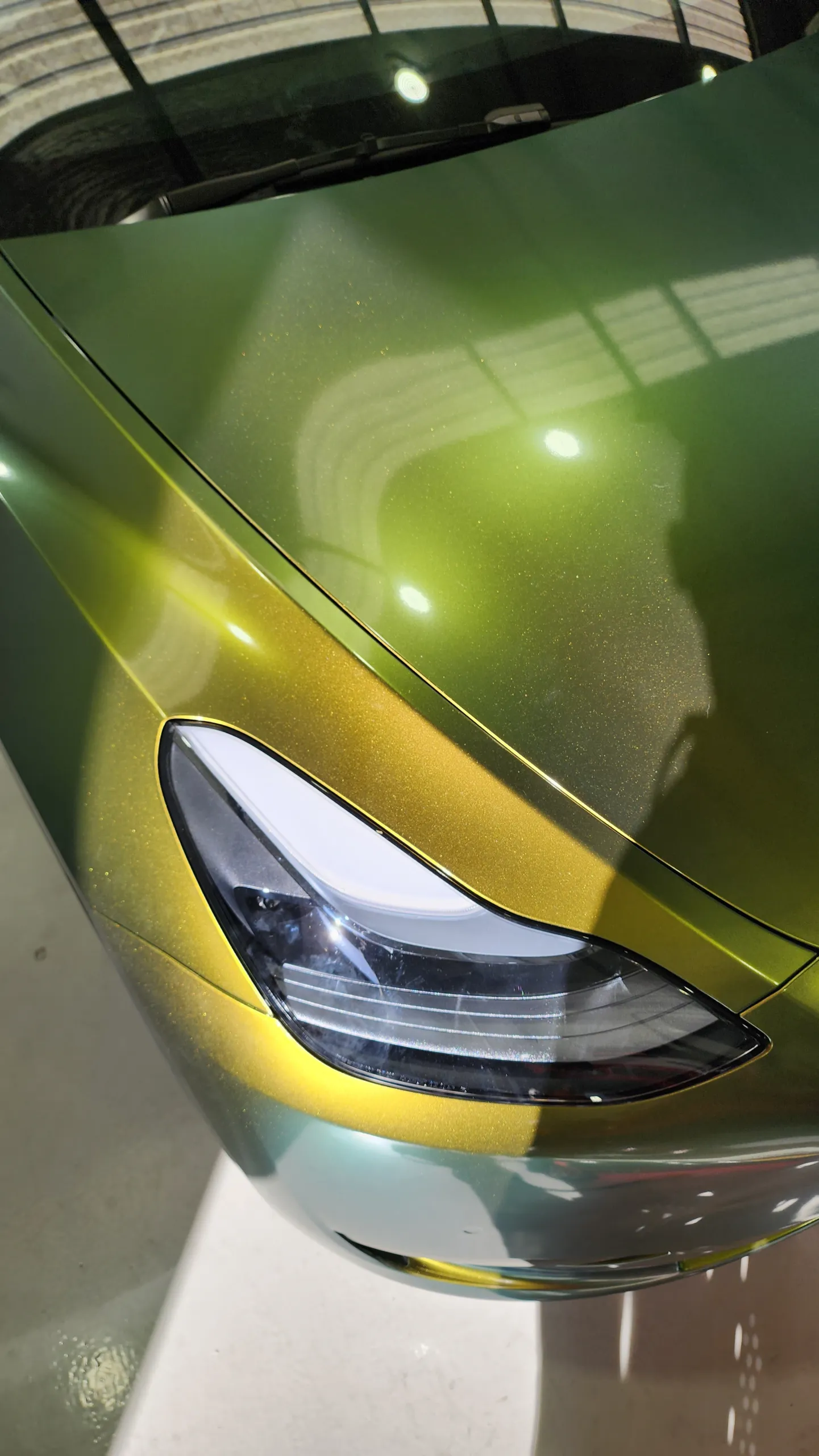 Golden green colour-shift Tesla Model Y, front detail