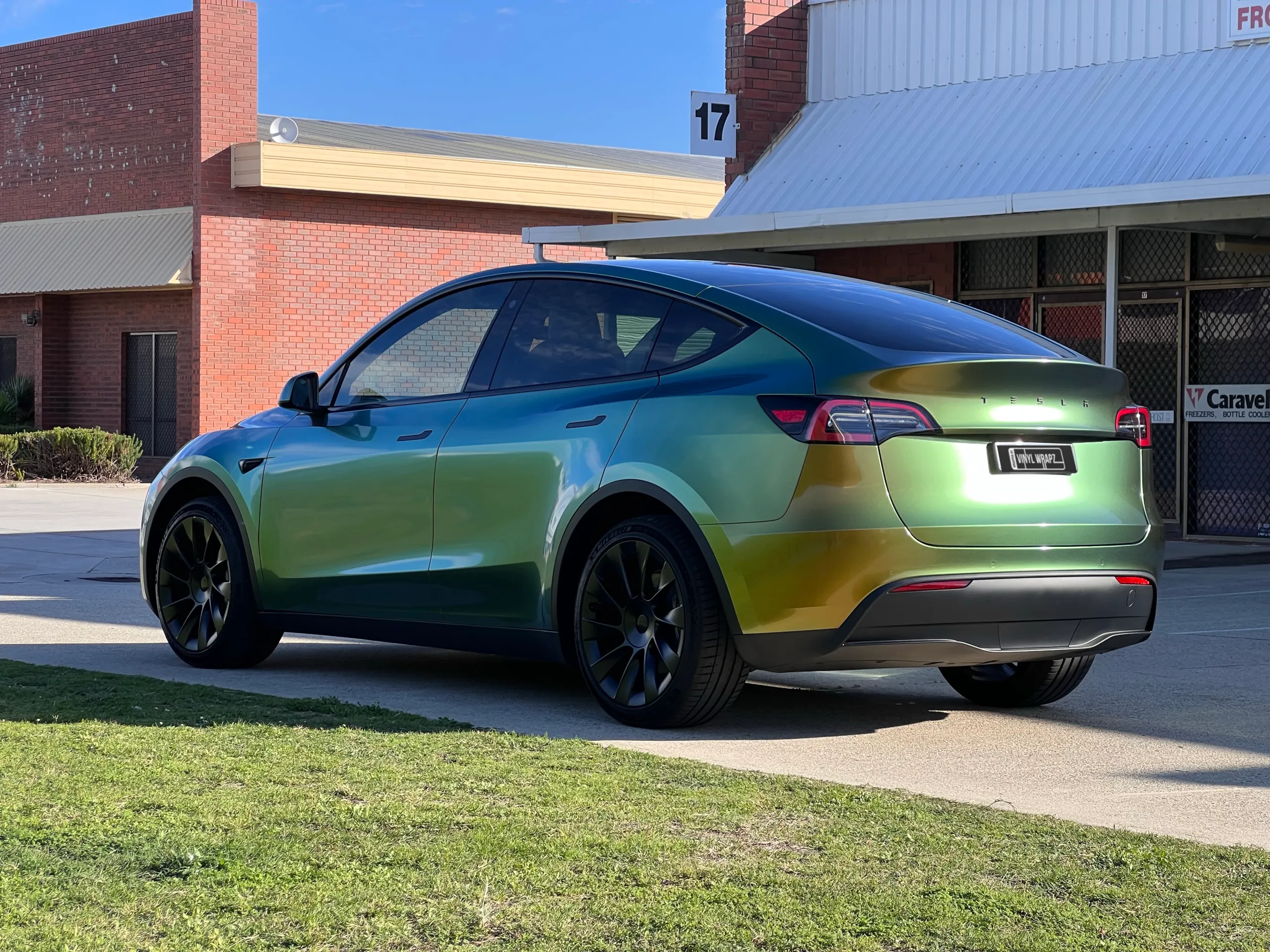 Golden green colour-shift Tesla Model Y, rear quarter