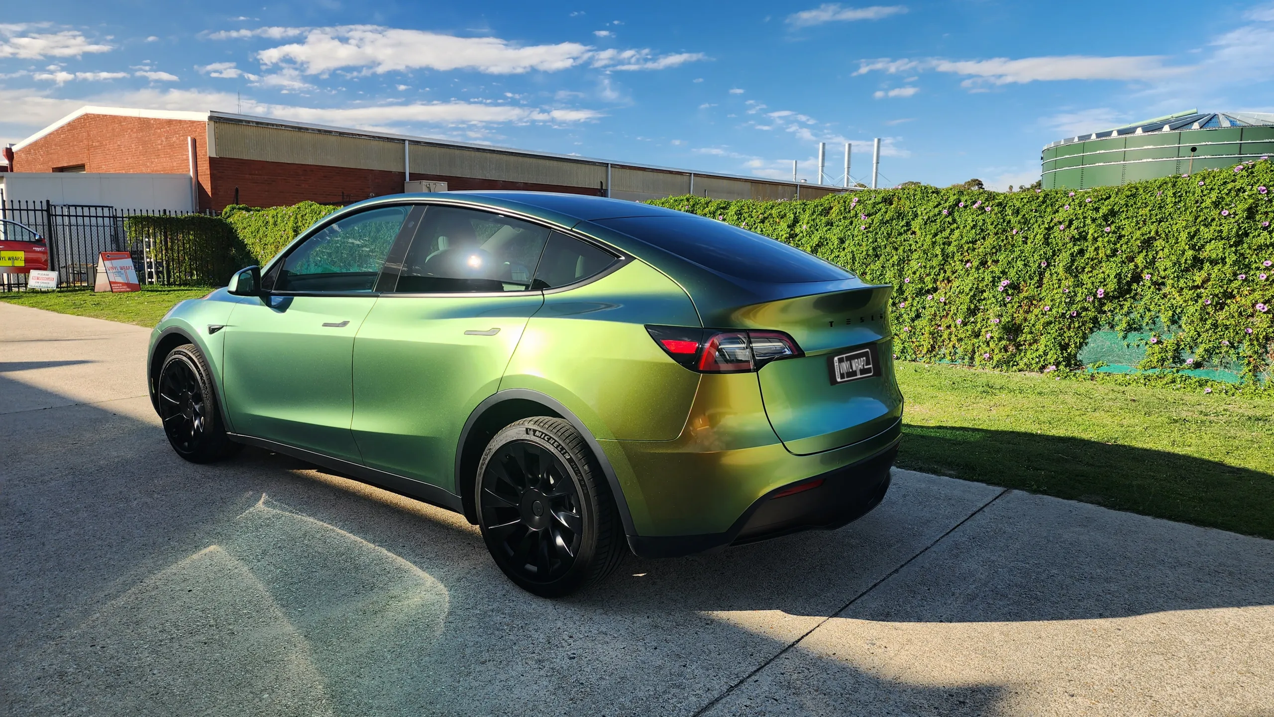 Golden green colour-shift Tesla Model Y, rear quarter
