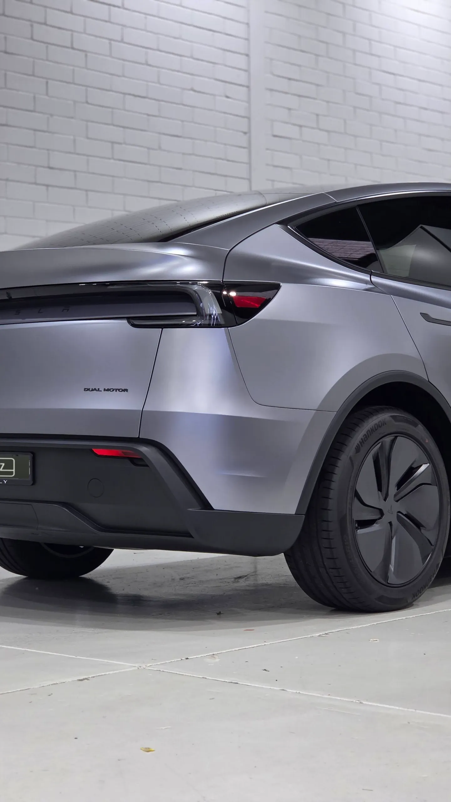 Satin grey Tesla Model Y rear quarter, tailgate and rear wheel