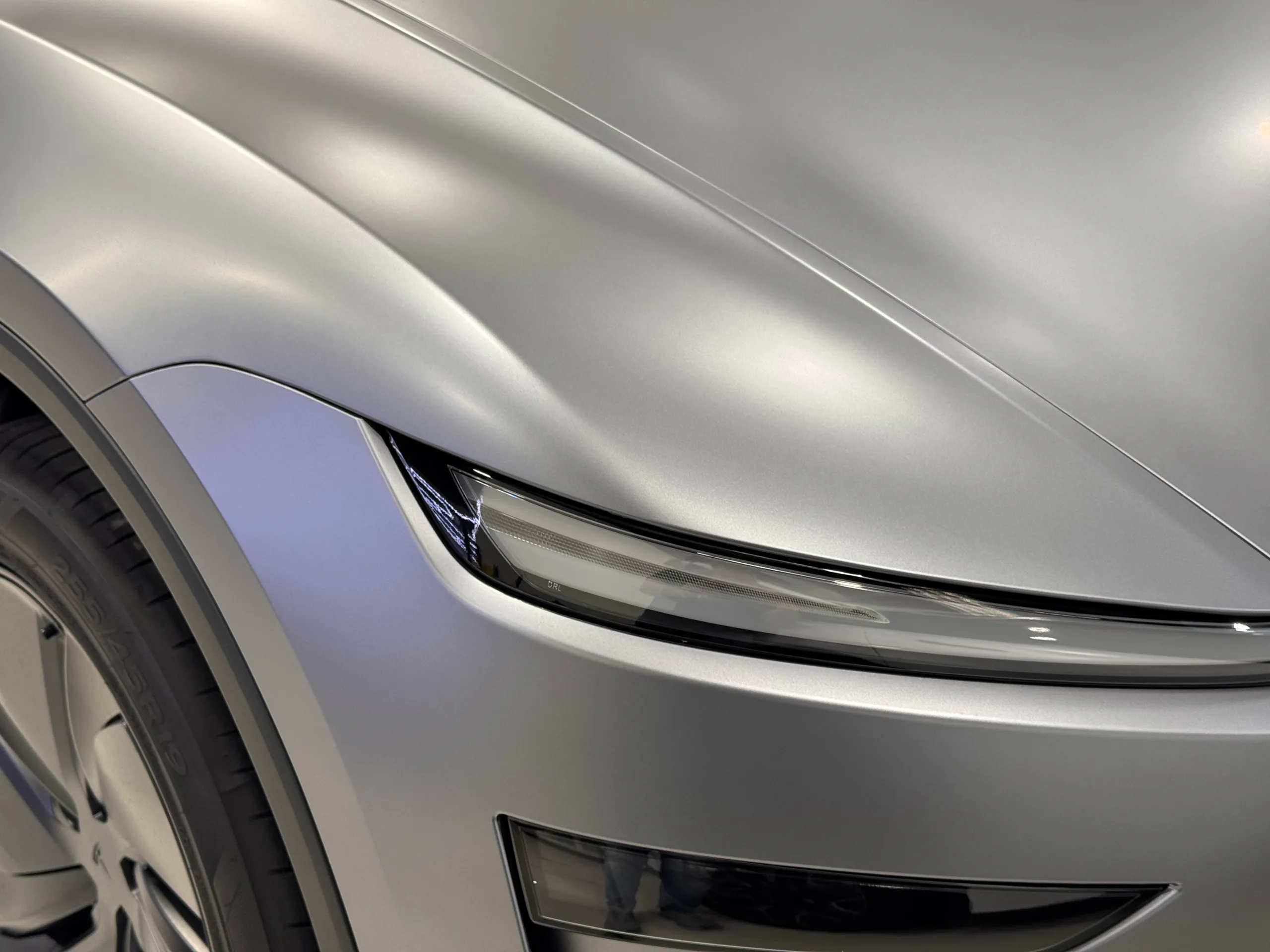 Close view of the satin grey Tesla Model Y bonnet and front light bar