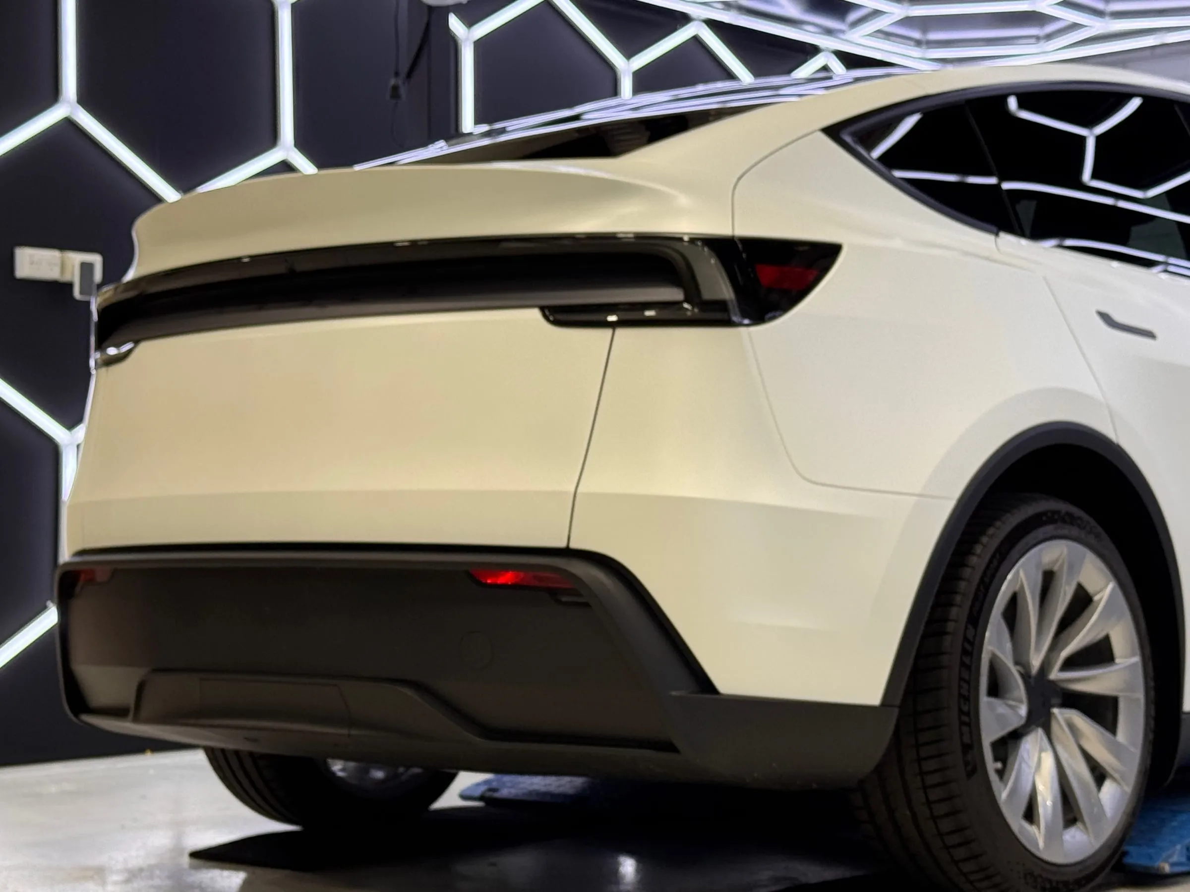 Rear quarter panel, bumper and taillight of a white Tesla Model Y in paint protection film, Osborne Park