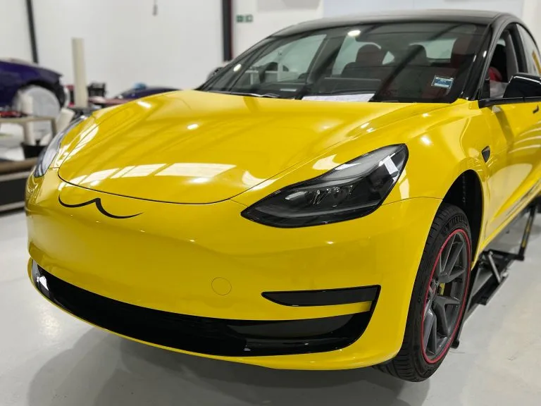 Tesla Model 3 in a gloss yellow colour change wrap with a gloss black roof at Vinyl Wrapz