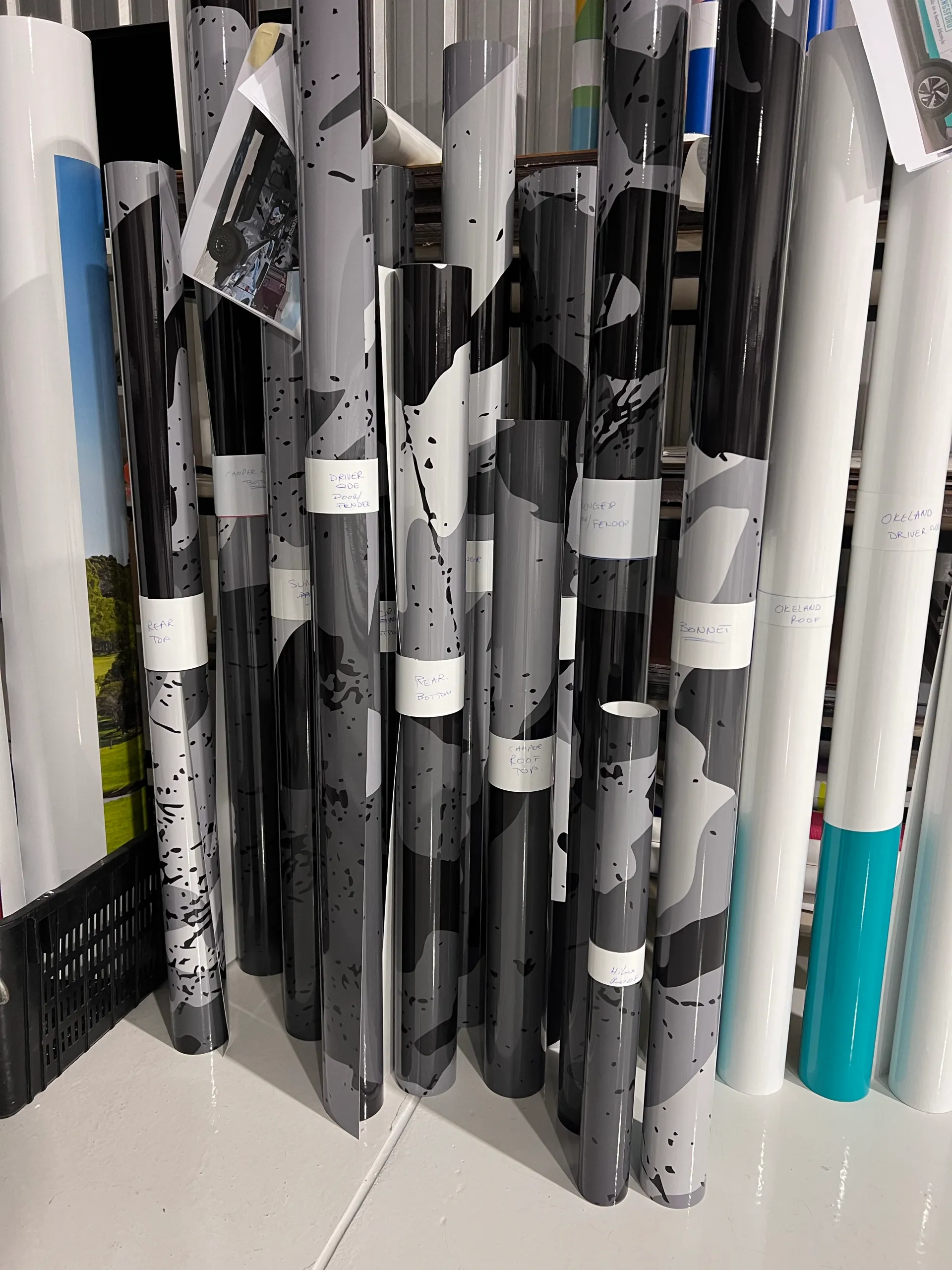 Rolls of grey camouflage printed film prepared for the Hilux Suncamper wrap
