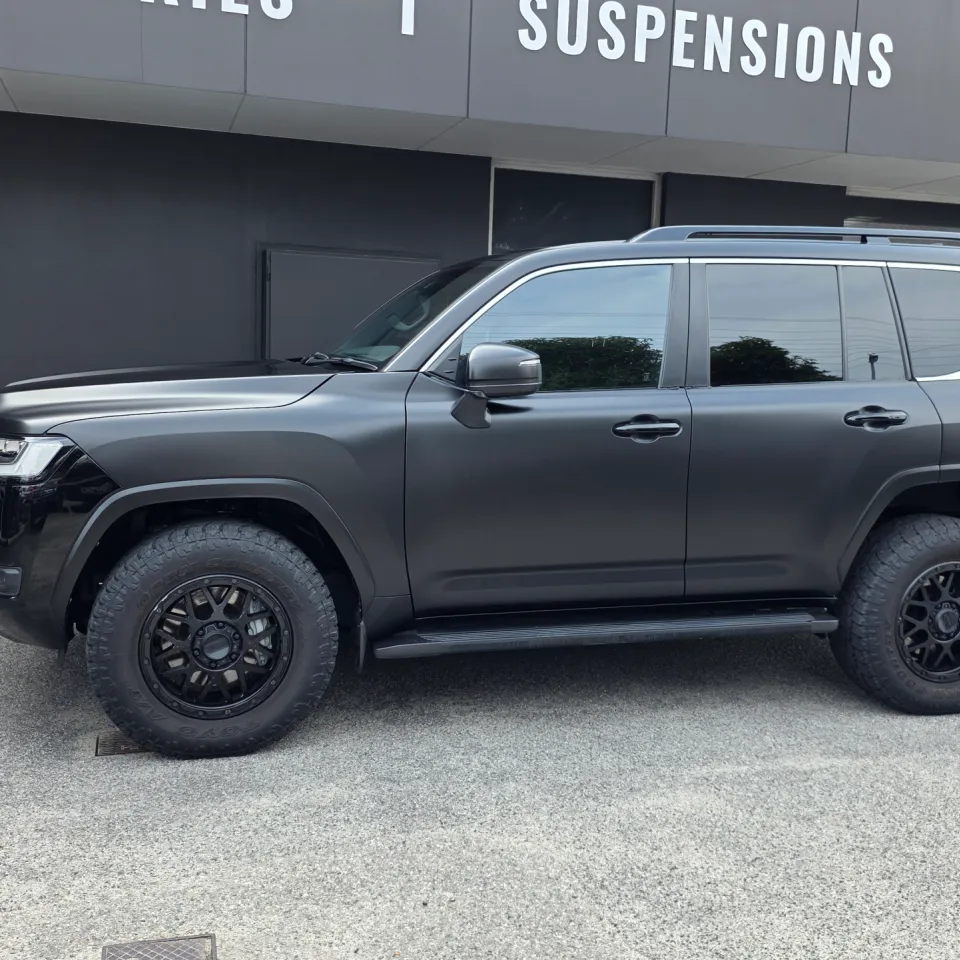 Side profile of the satin black Toyota LandCruiser 300 with black wheels