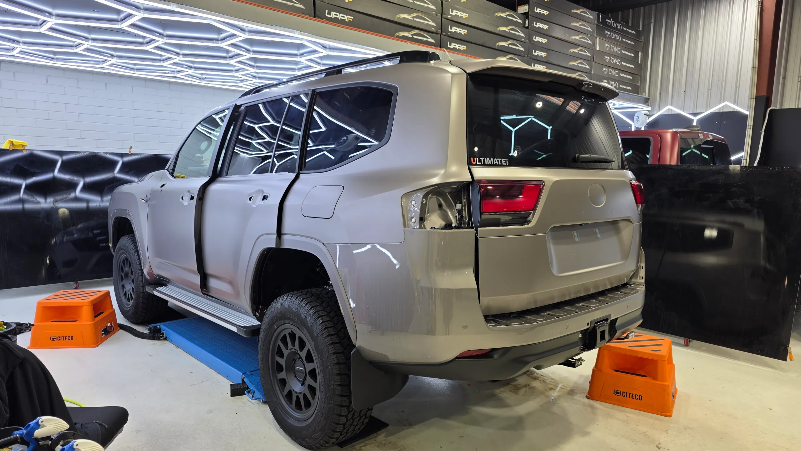 LandCruiser 300 rear quarter during satin conversion with the rear light and door handles removed