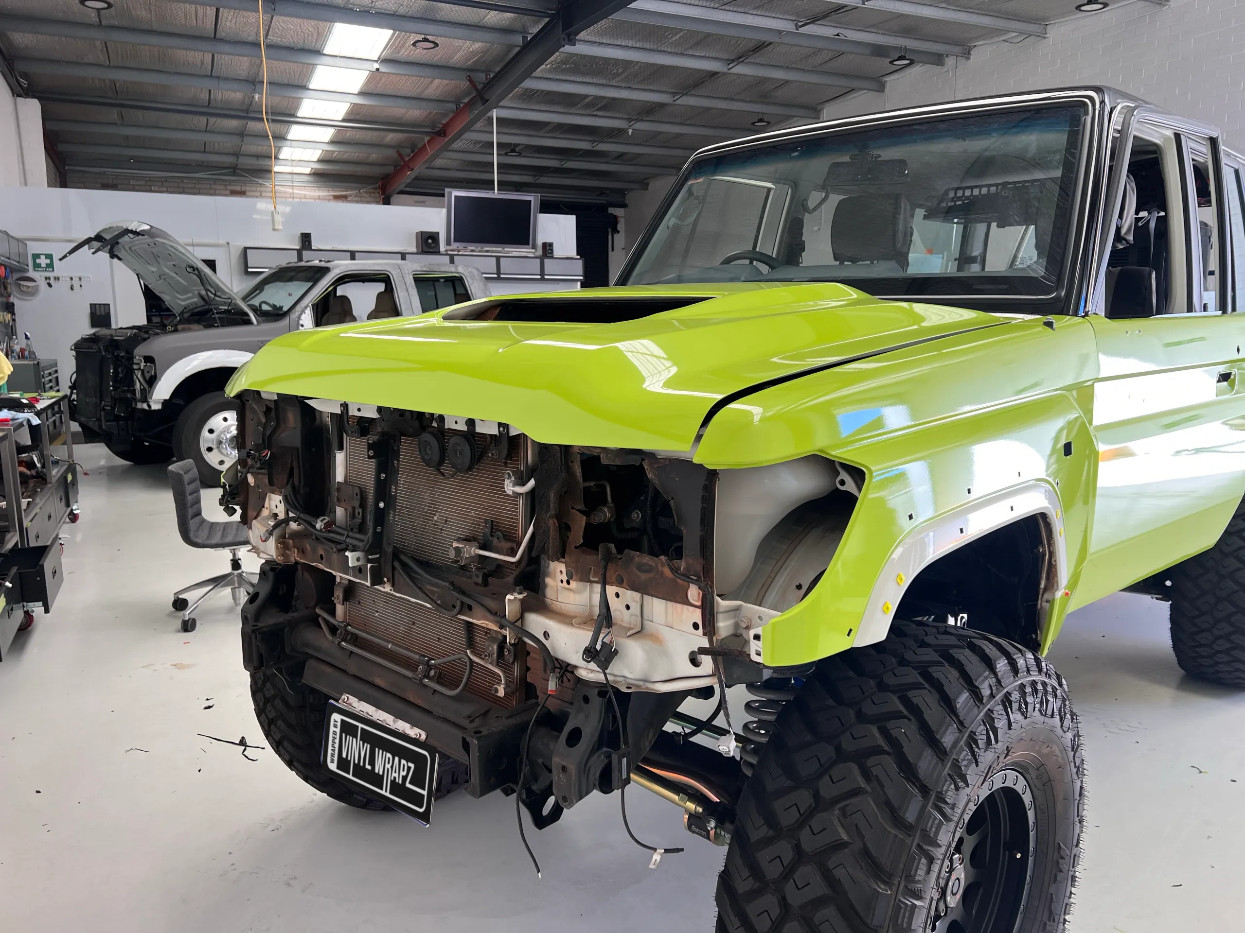 Lime green and black Toyota LandCruiser 76 Series, front quarter