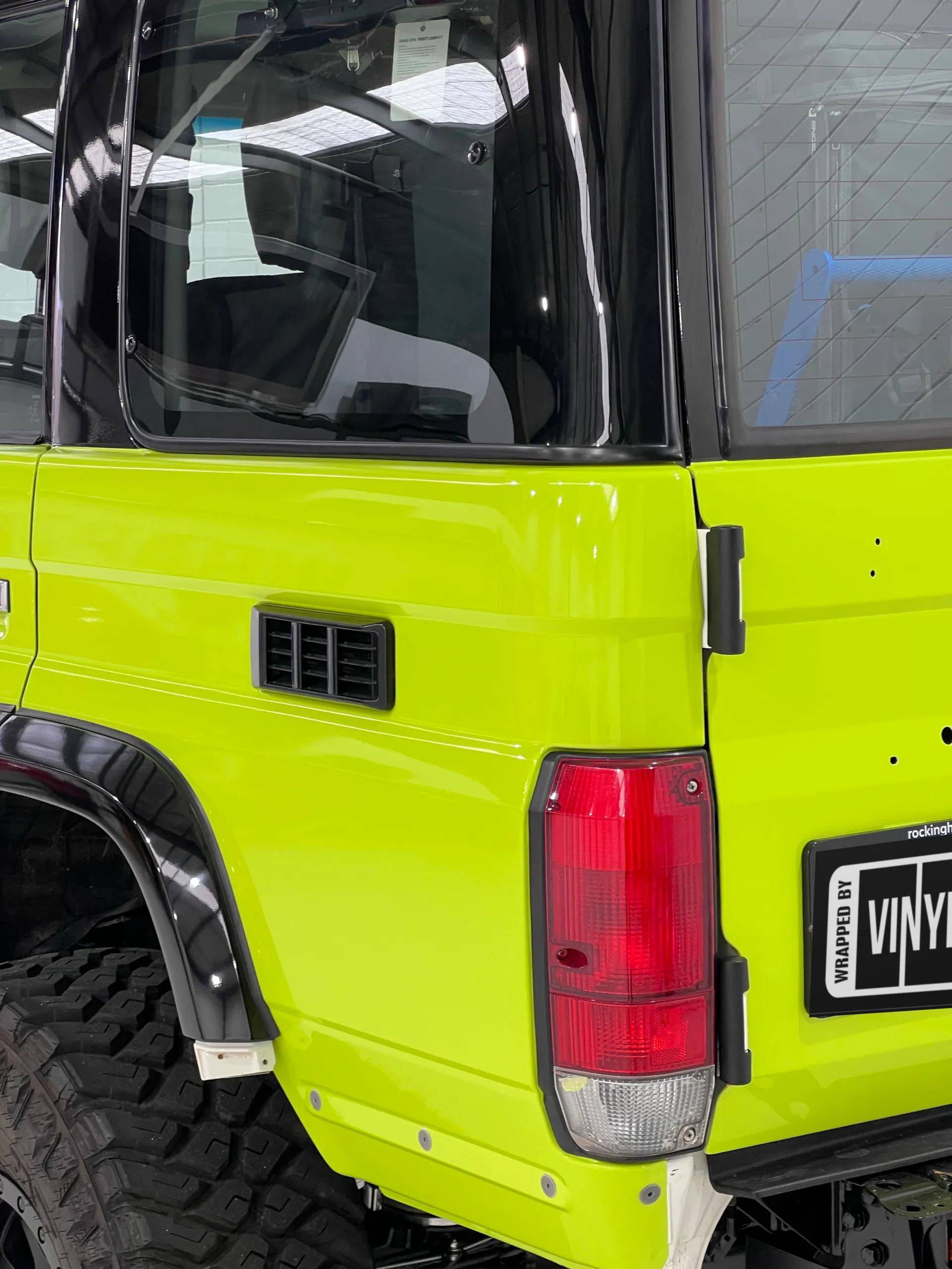 Lime green and black Toyota LandCruiser 76 Series, rear detail
