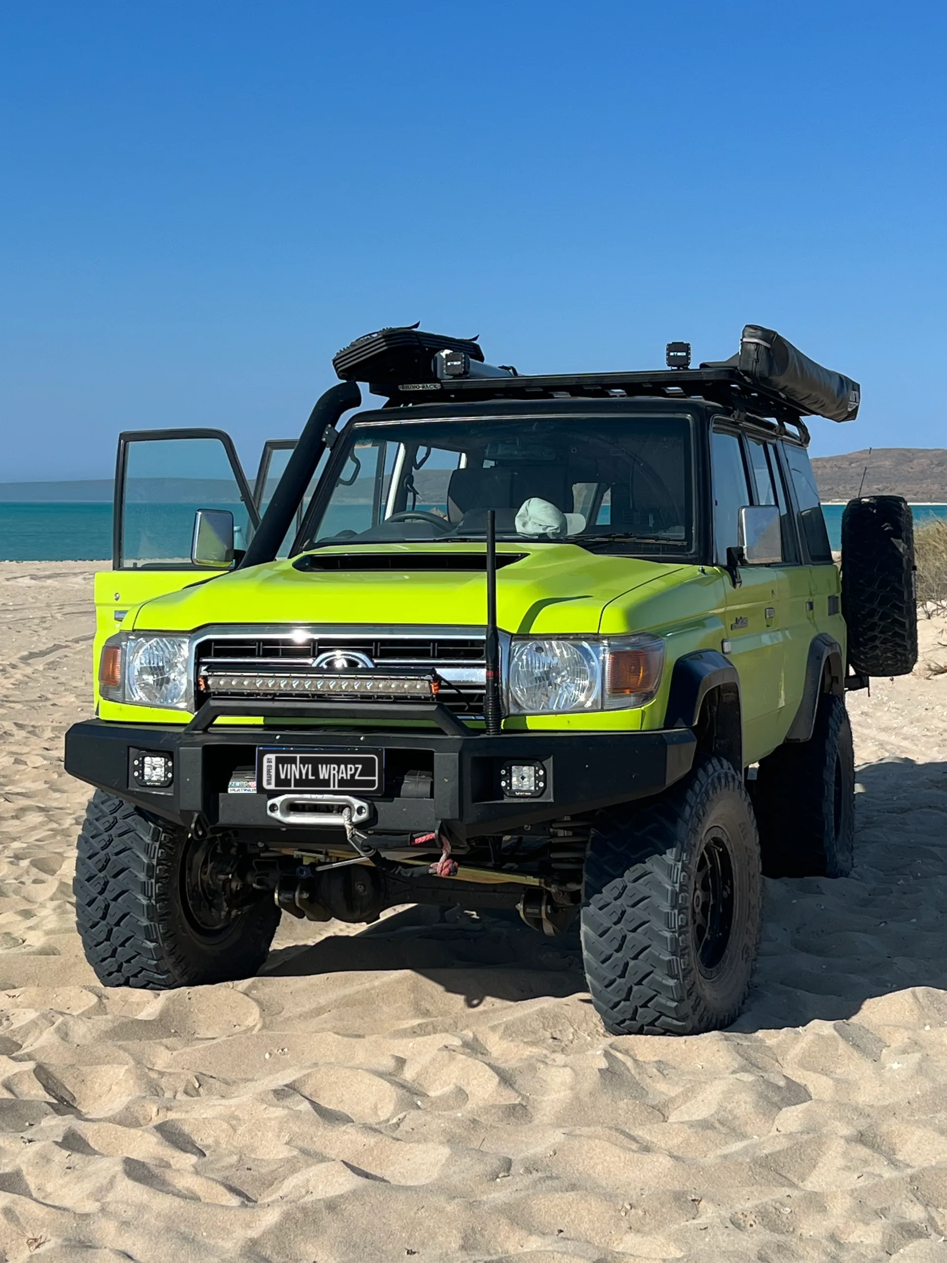 Lime green and black Toyota LandCruiser 76 Series, front