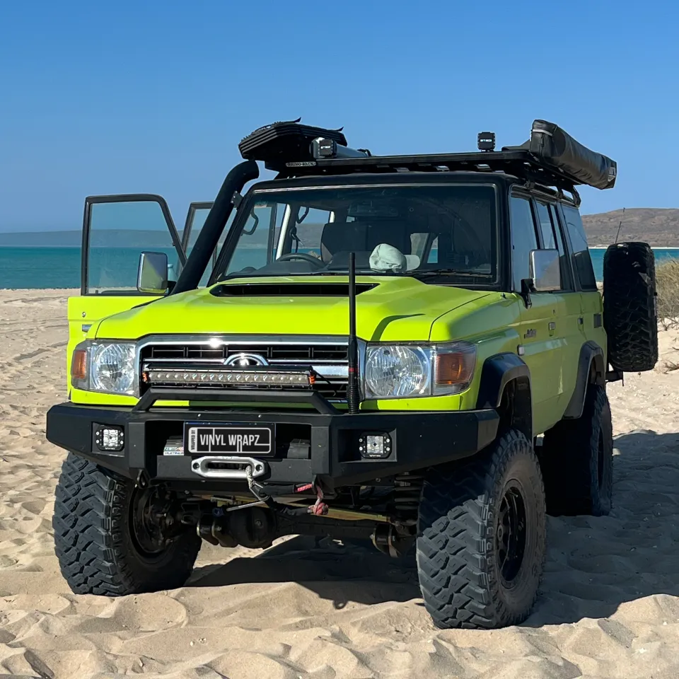 Lime green and black Toyota LandCruiser 76 Series, front