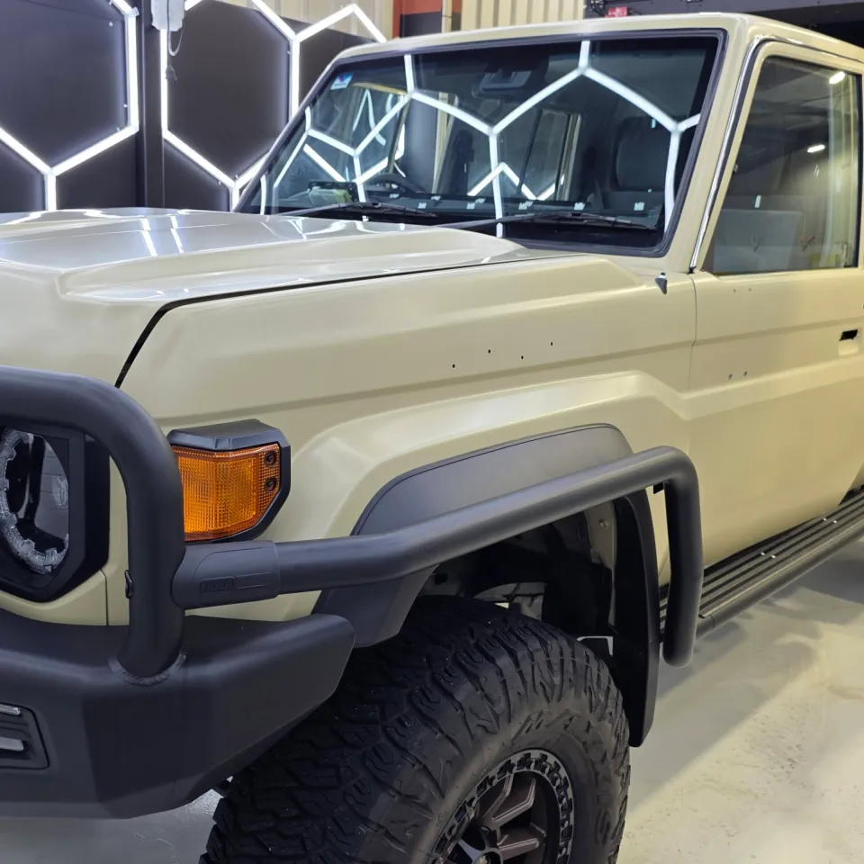 Cream Toyota LandCruiser 79 during preparation with door handles and trim removed