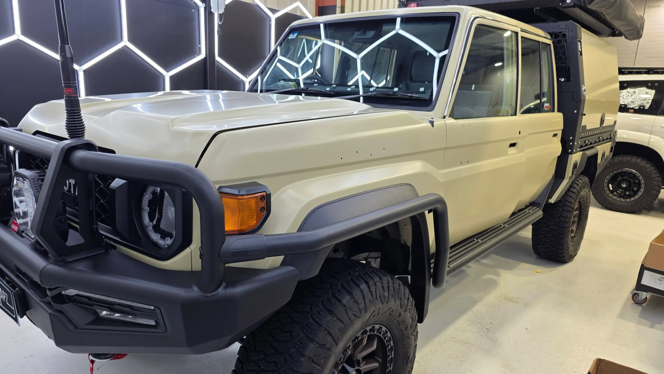Cream Toyota LandCruiser 79 during preparation with door handles and trim removed