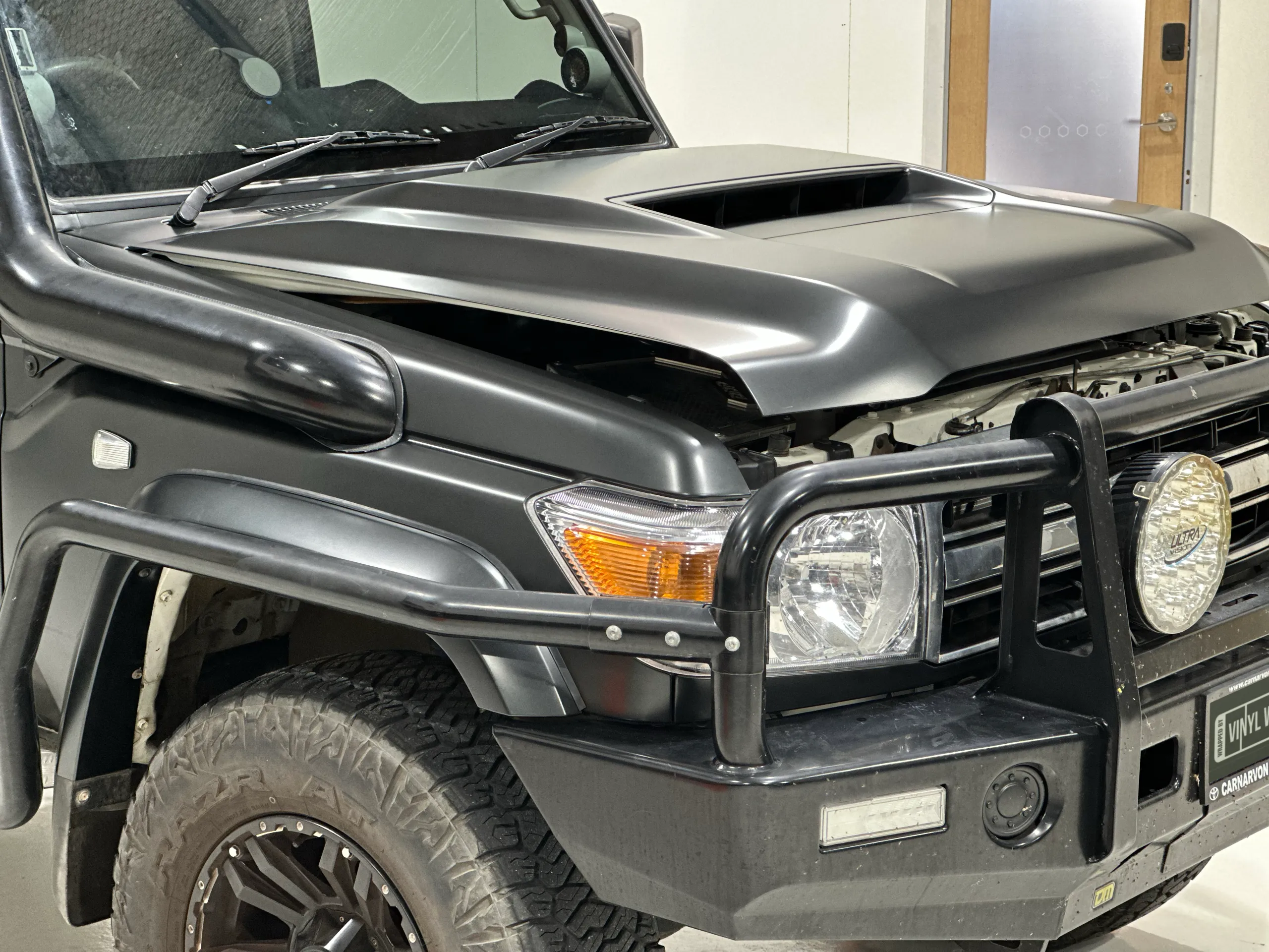 LandCruiser bonnet, headlight and bullbar with the bonnet partly open