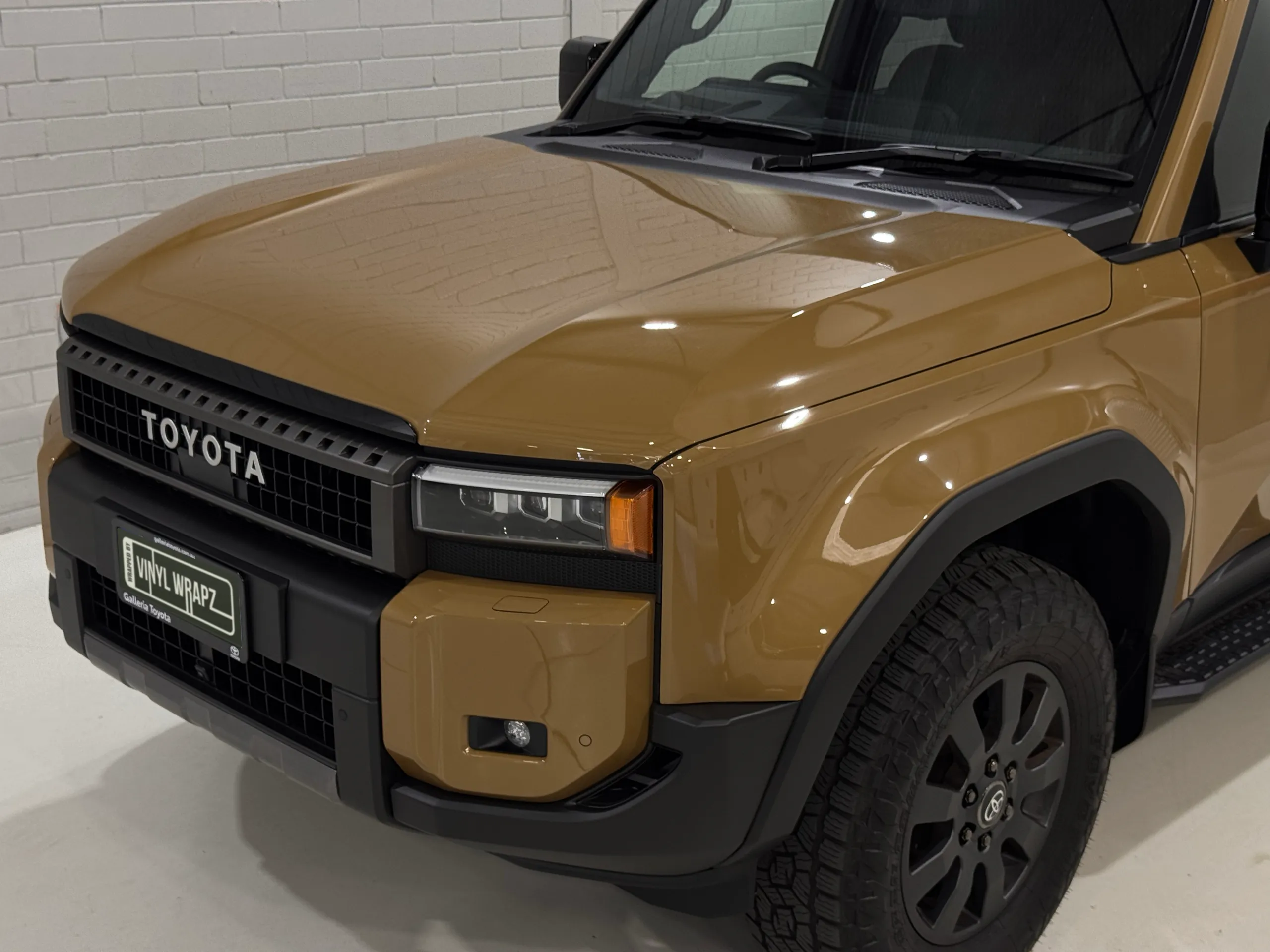 Gloss gold Toyota LandCruiser Prado bonnet and front guard in the workshop