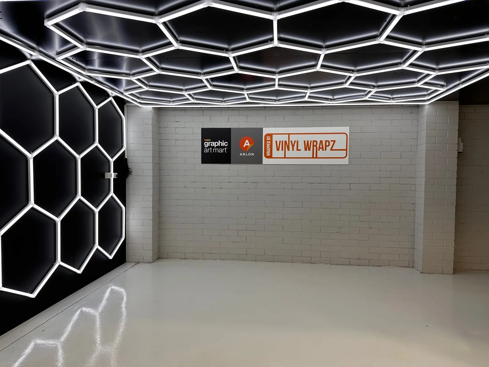 The inspection bay at Vinyl Wrapz with its hex lighting wall