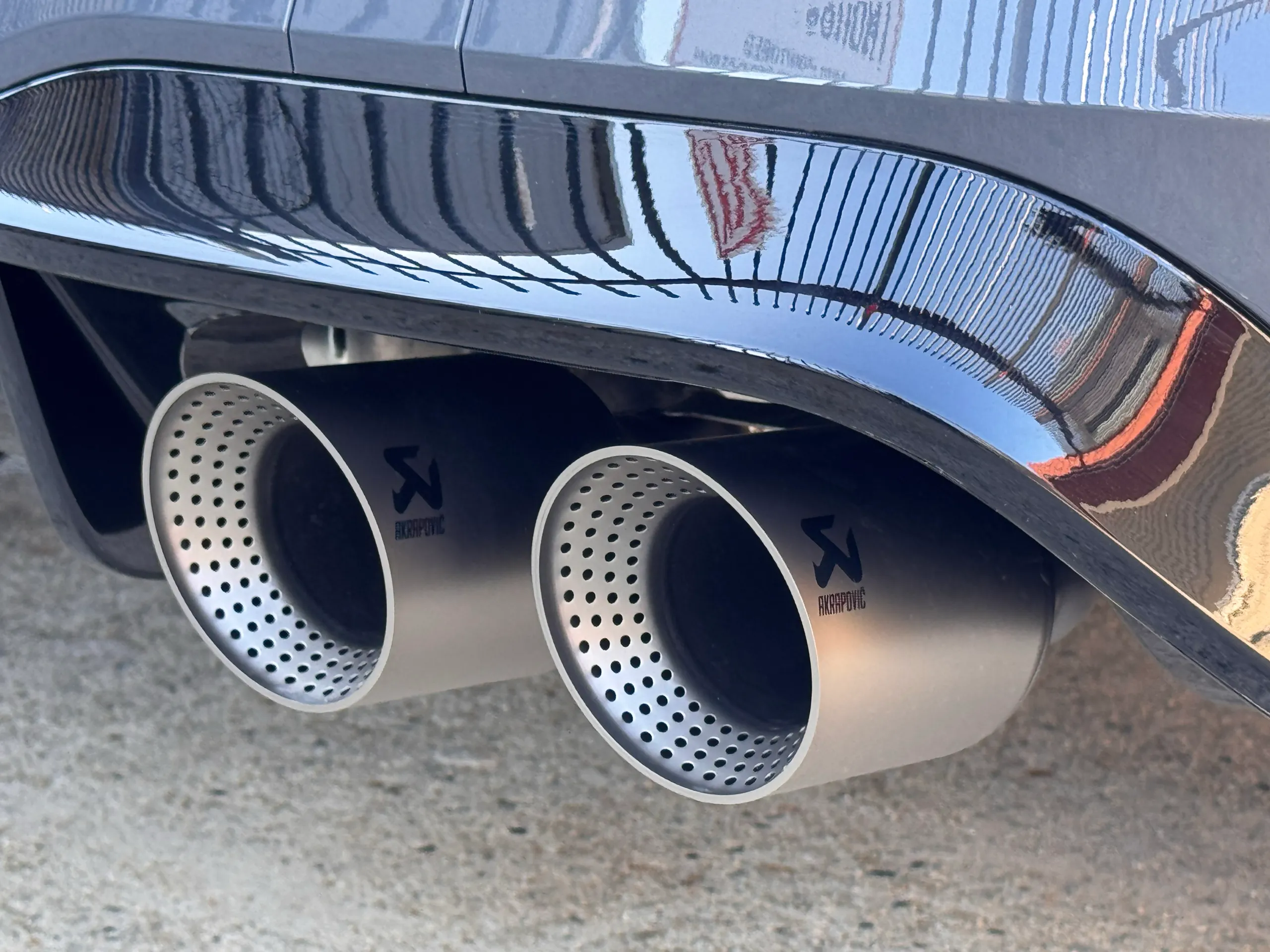 Twin exhaust tips beneath the grey Golf R rear bumper