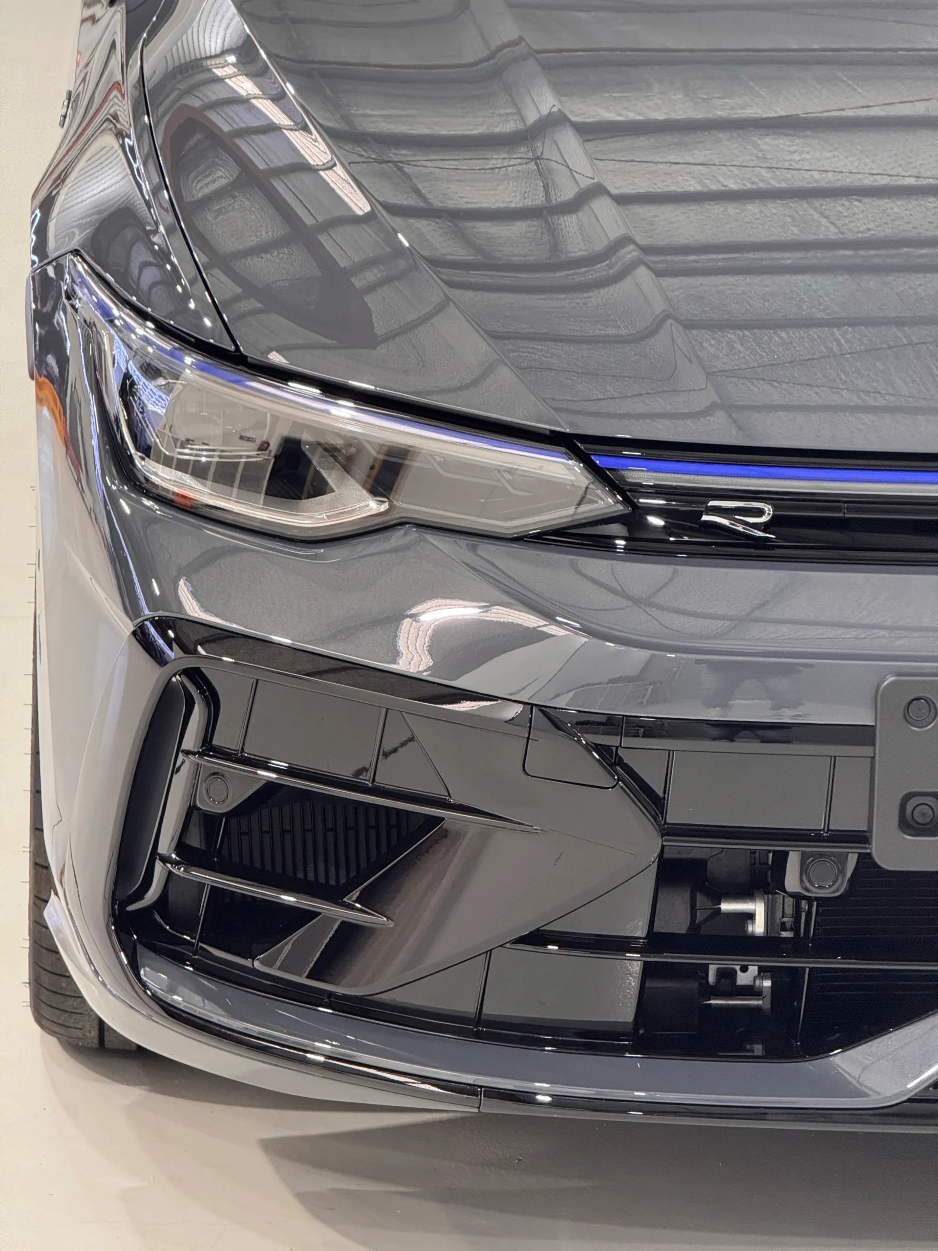 Golf R headlight and grey front bumper with an R grille badge