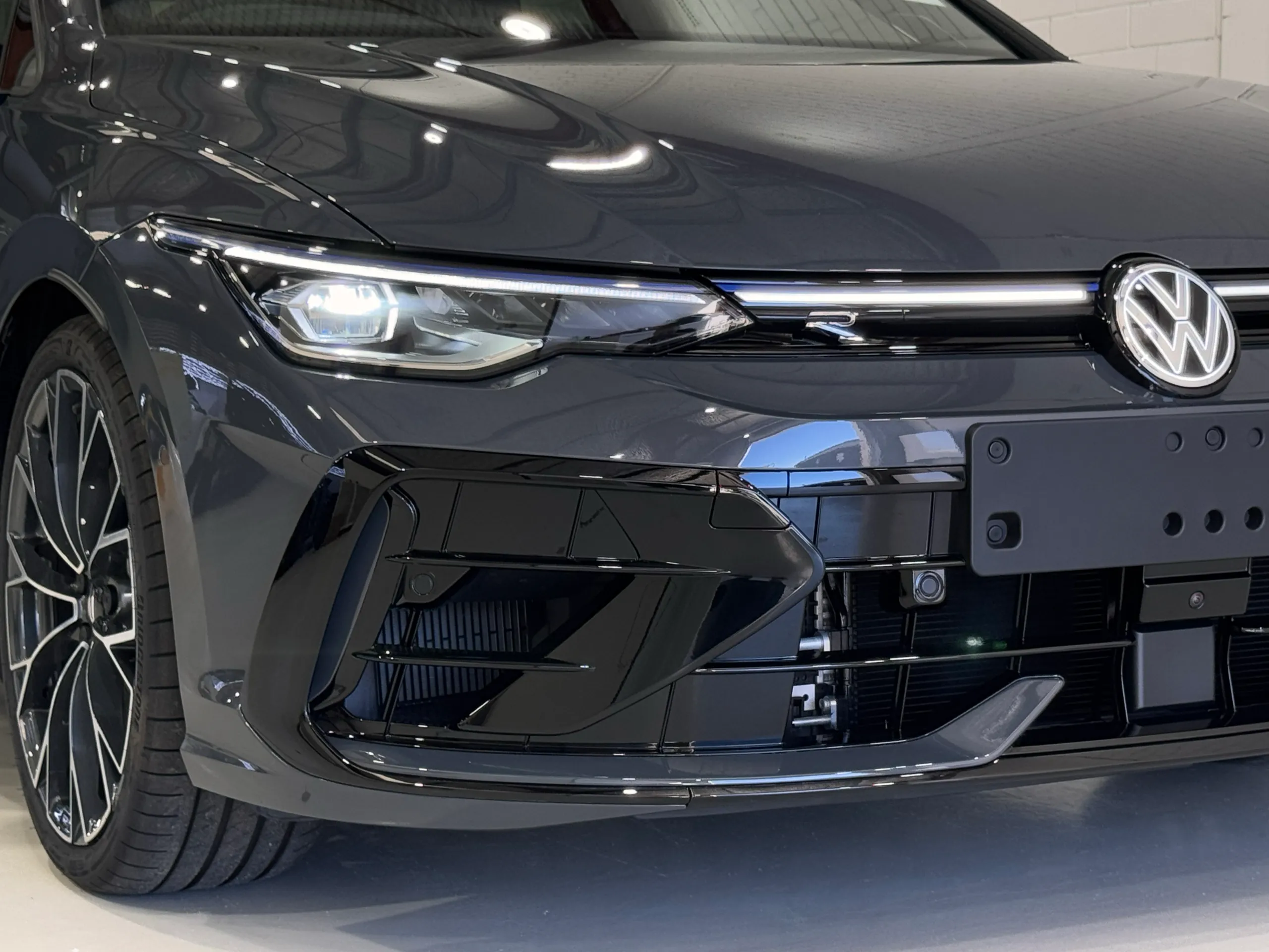 Volkswagen Golf R headlight and front grille with the light switched on