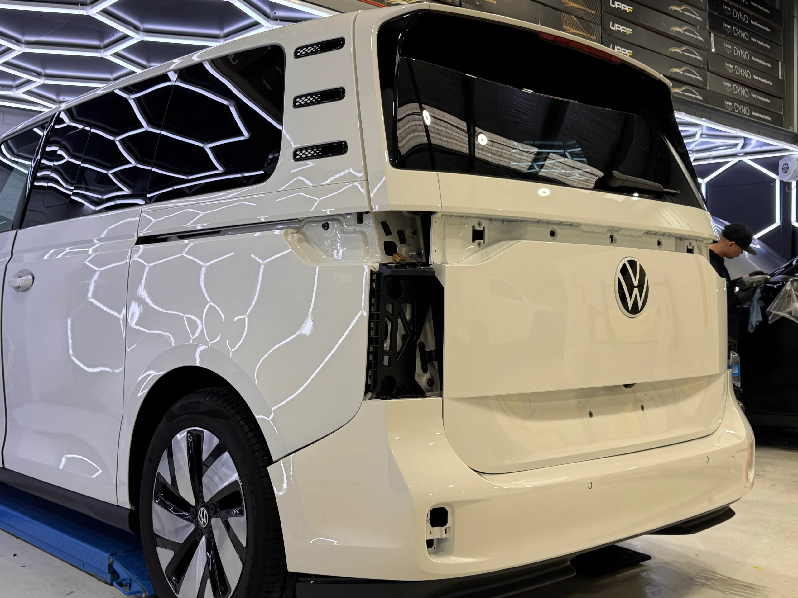 White Volkswagen ID. Buzz rear quarter during preparation, with rear lights and trim removed