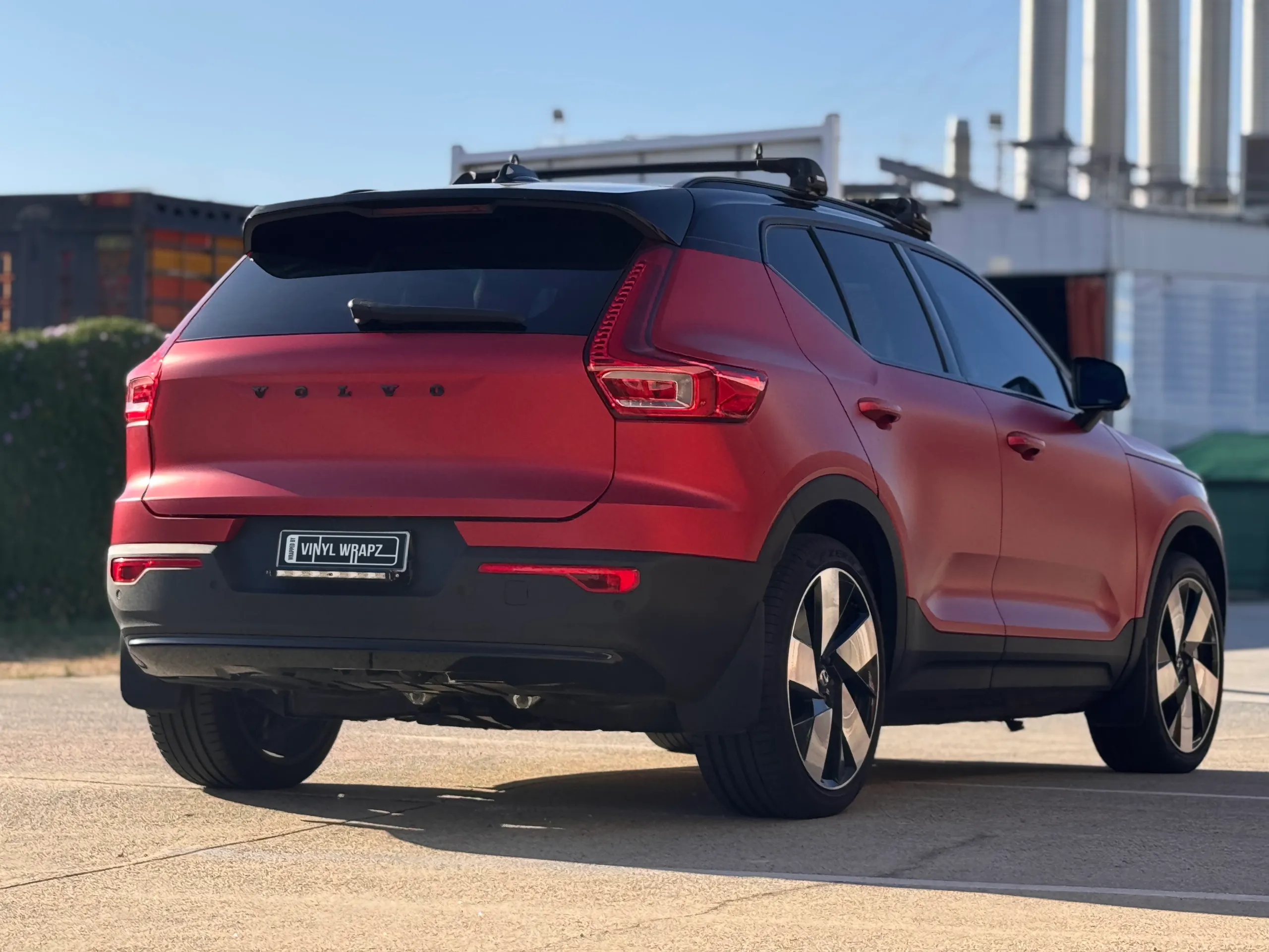 Rear-quarter view of the red Volvo XC40 with black lower trim
