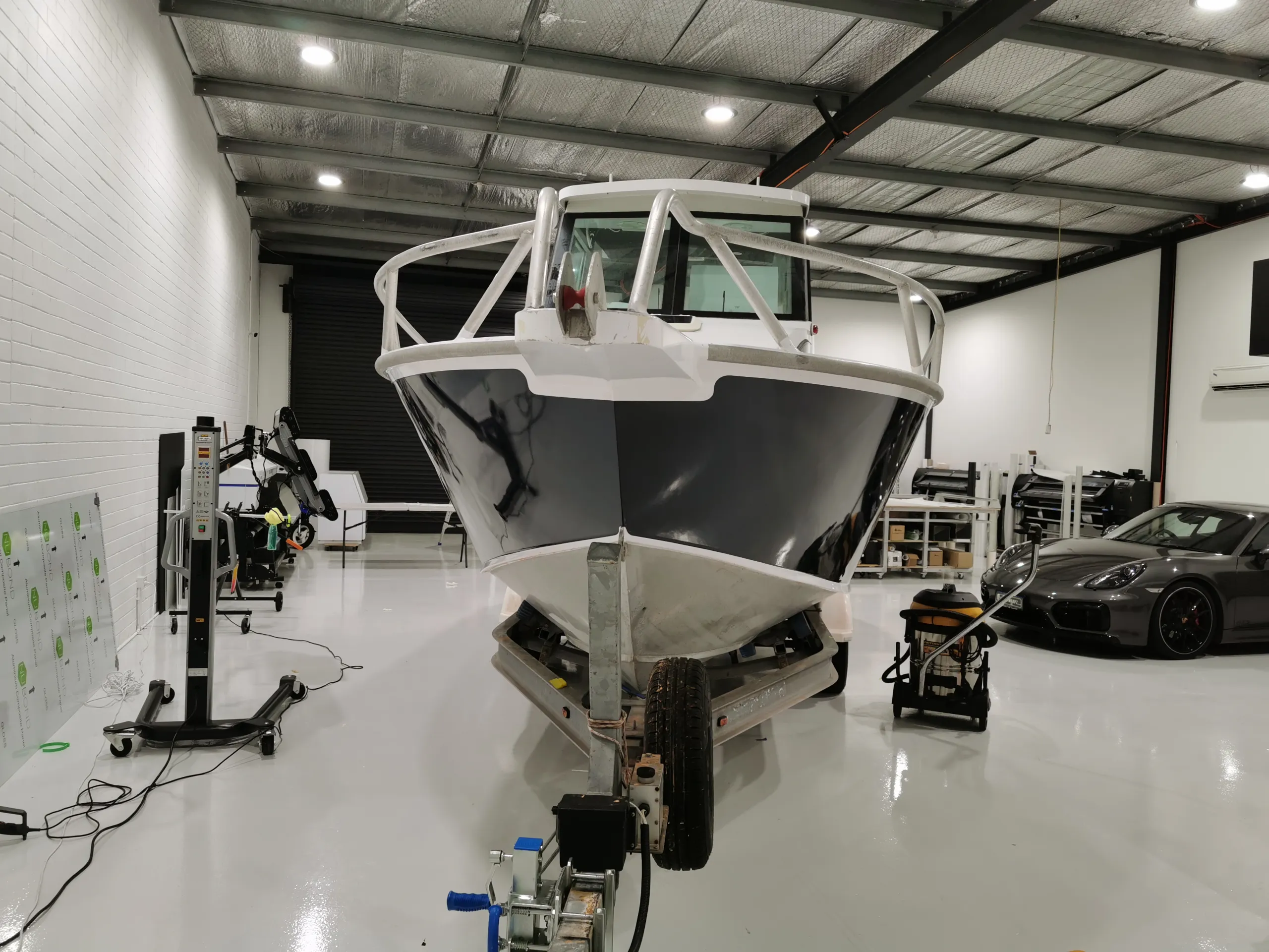 Head-on view of the charcoal boat bow beneath its white bow rail