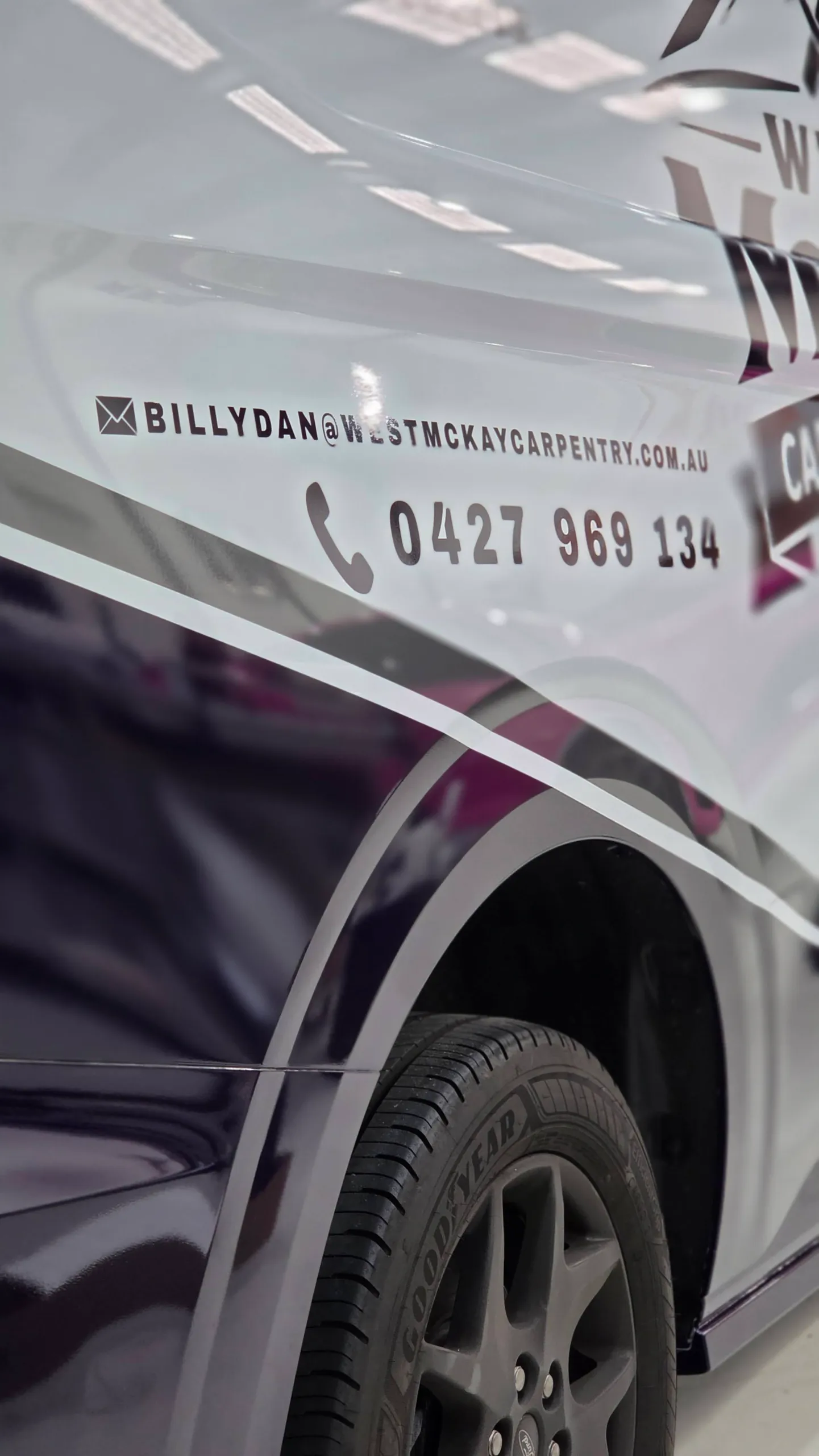 Navy and grey graphics around the West McKay van rear wheel and contact lettering