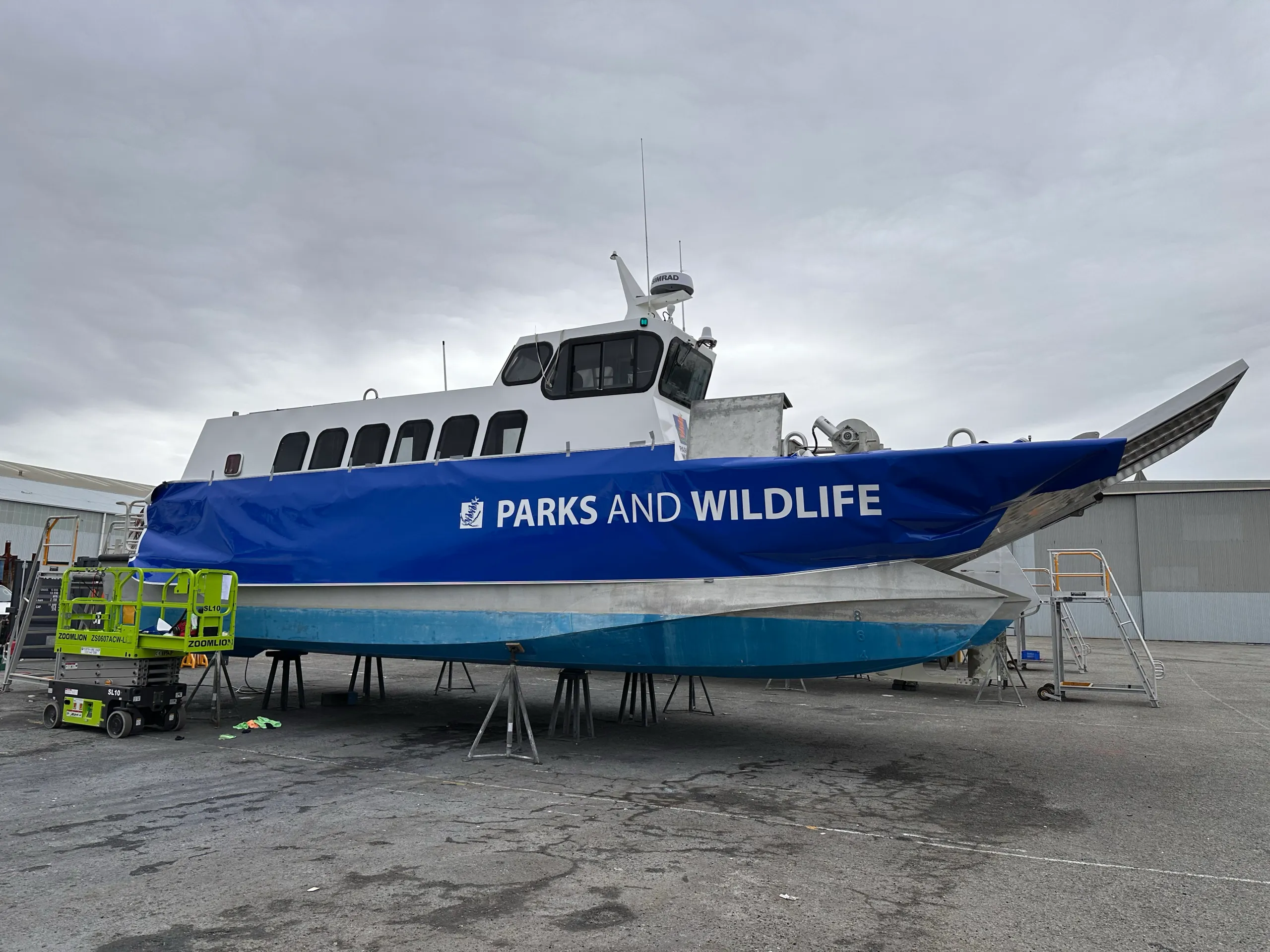 Loose blue Parks and Wildlife film positioned along the Wirruwana vessel hull on a hardstand