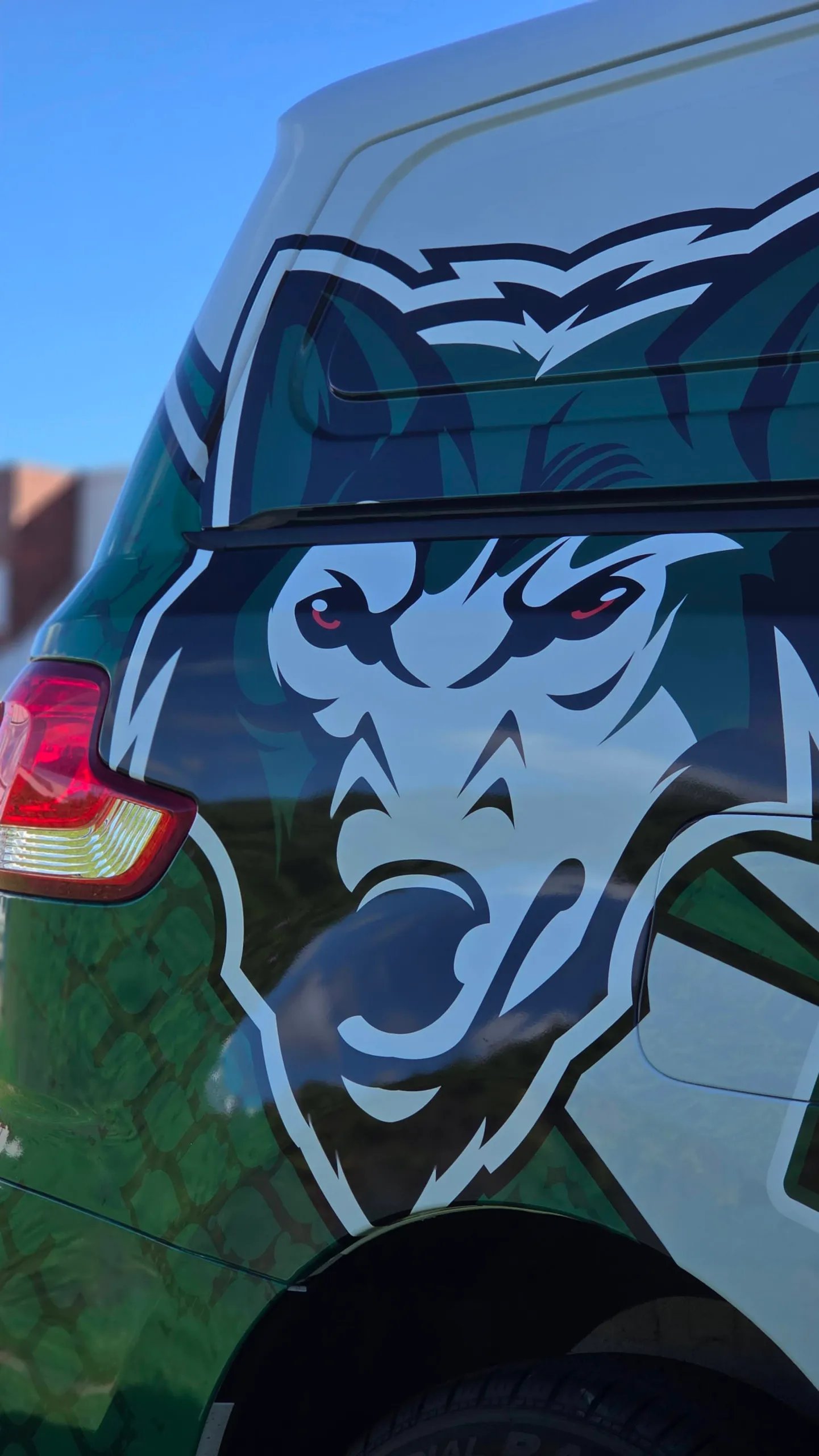 Large wolf-head artwork across the green rear quarter of the LDV van