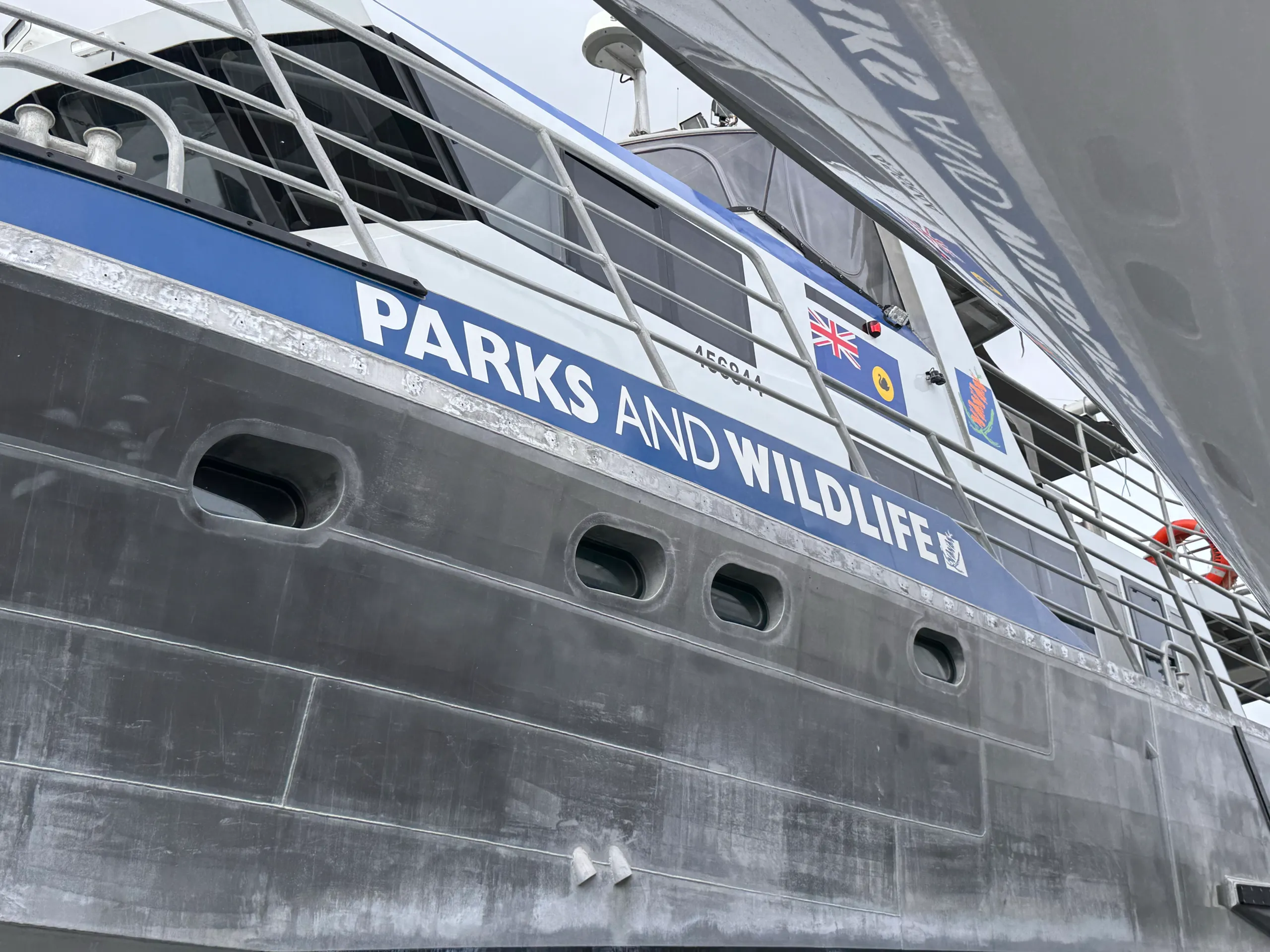 Parks and Wildlife lettering on a blue band above the aluminium hull of Woonbalu