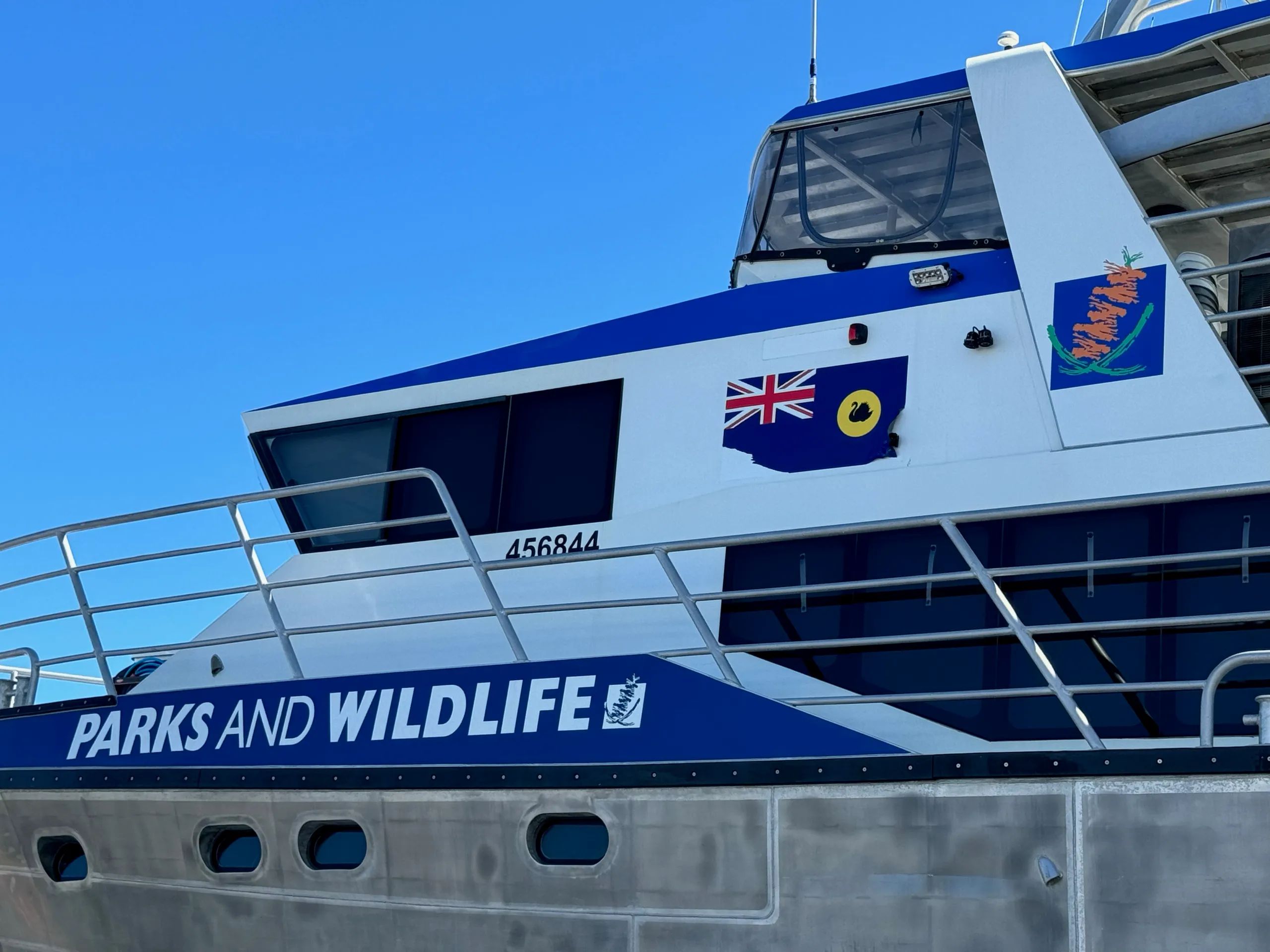 Parks and Wildlife lettering and blue cabin graphics on the Woonbalu vessel