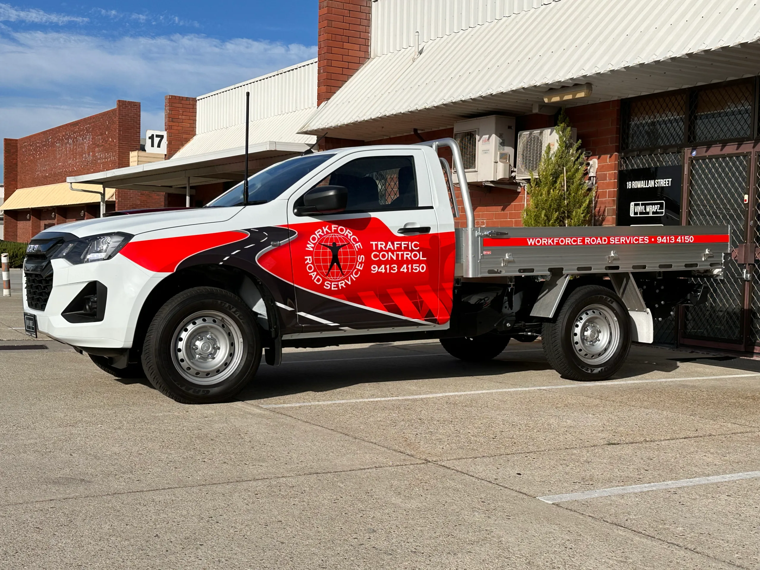 Workforce Road Services Isuzu D-MAX with red and black cab graphics outdoors