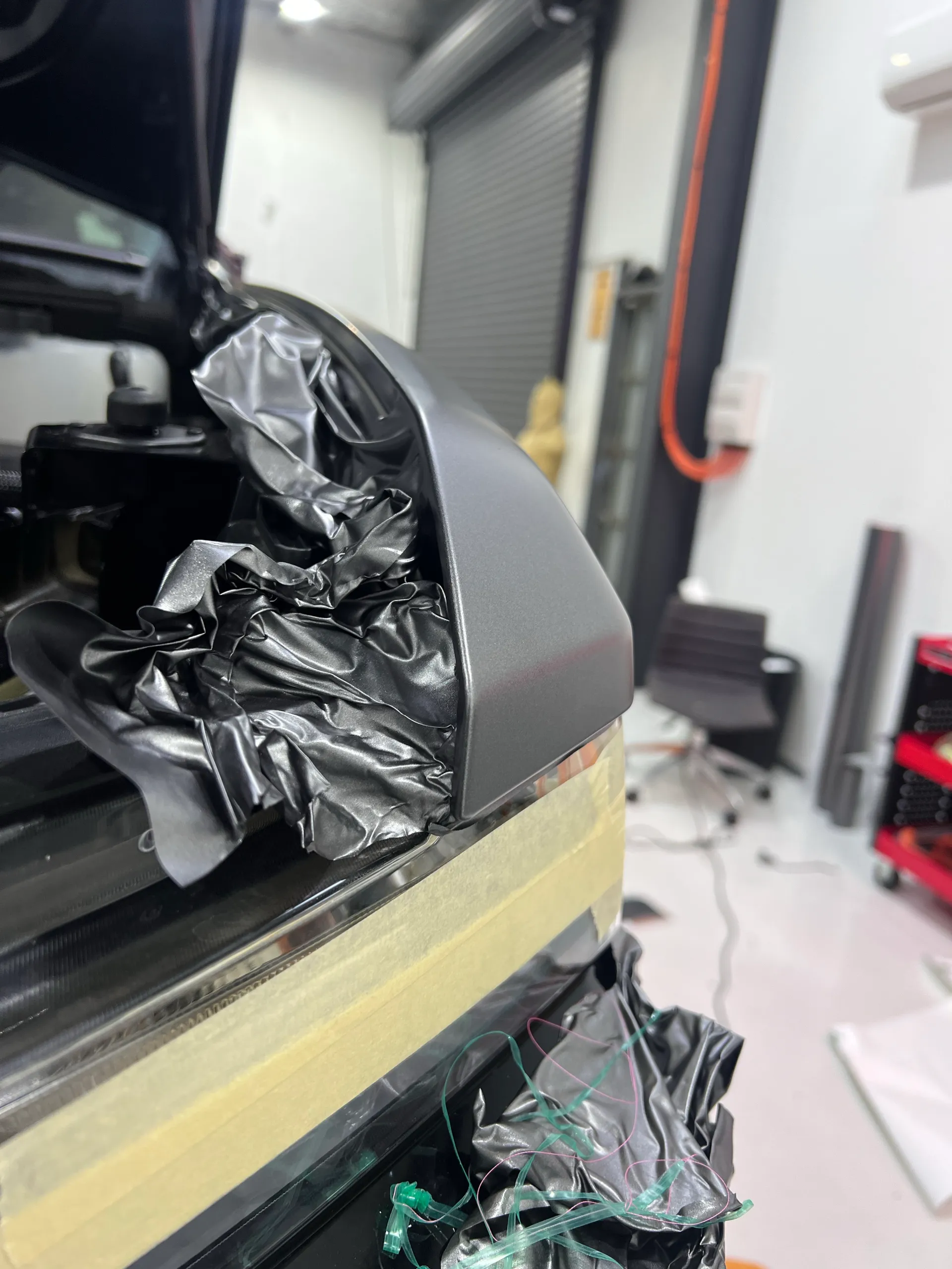 Matte film being finished around a Chevrolet Silverado headlight opening