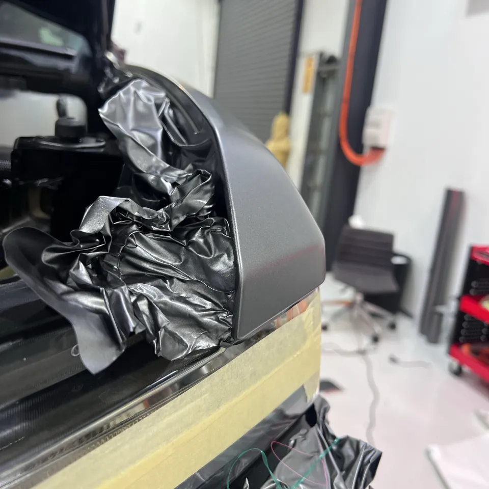 Matte film being finished around a Chevrolet Silverado headlight opening