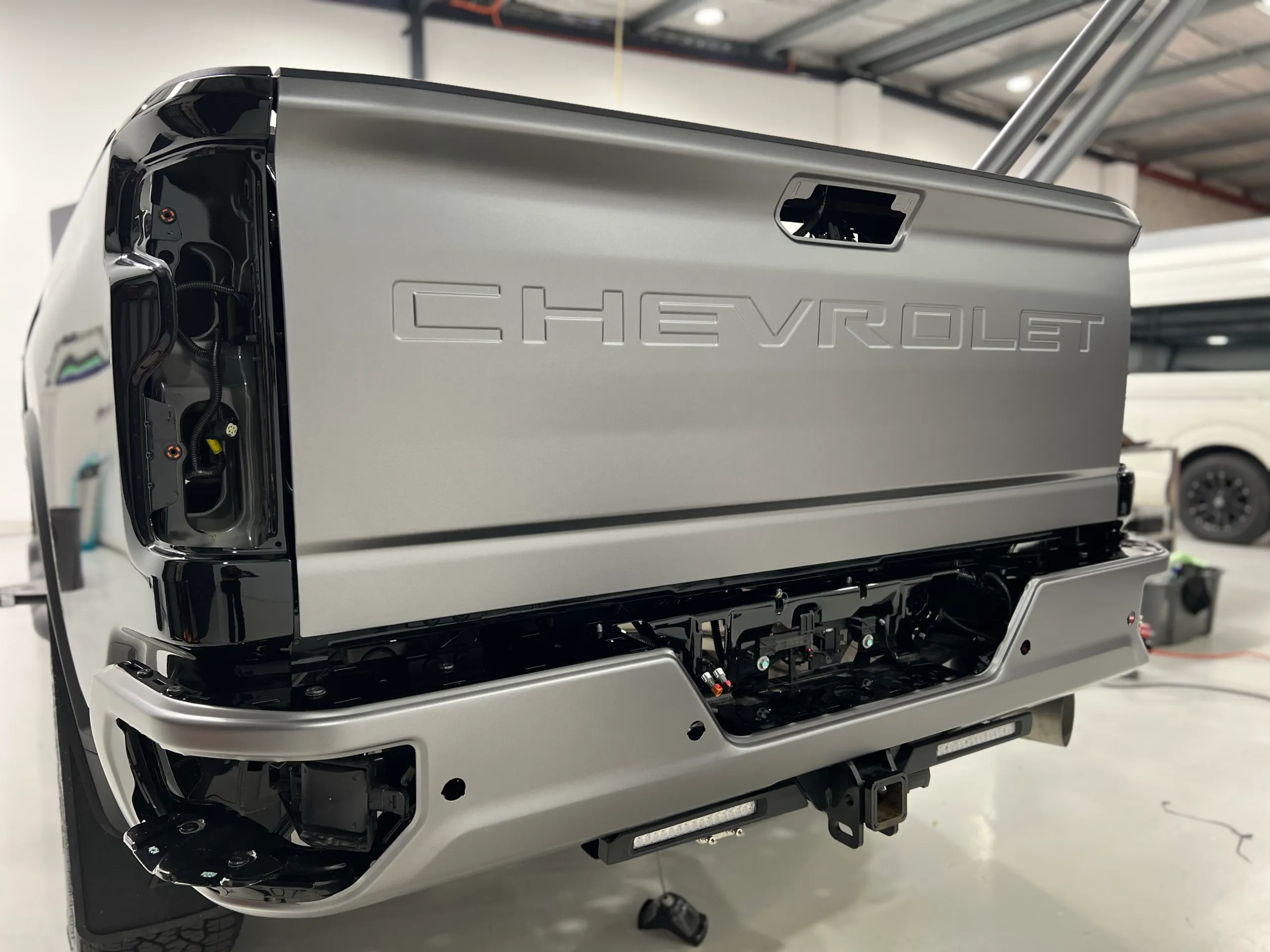 Matte anthracite film on a Chevrolet Silverado tailgate with rear lights removed