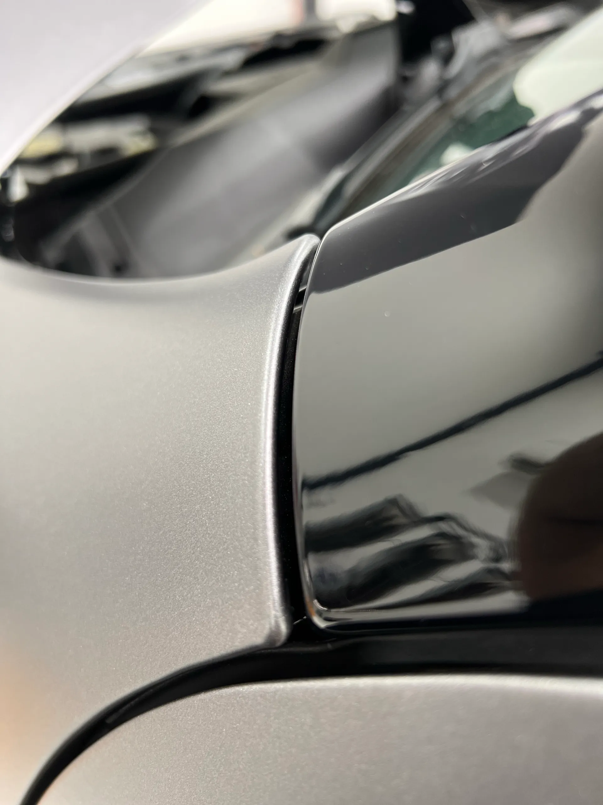 Close view of silver wrapped panel edges meeting black trim