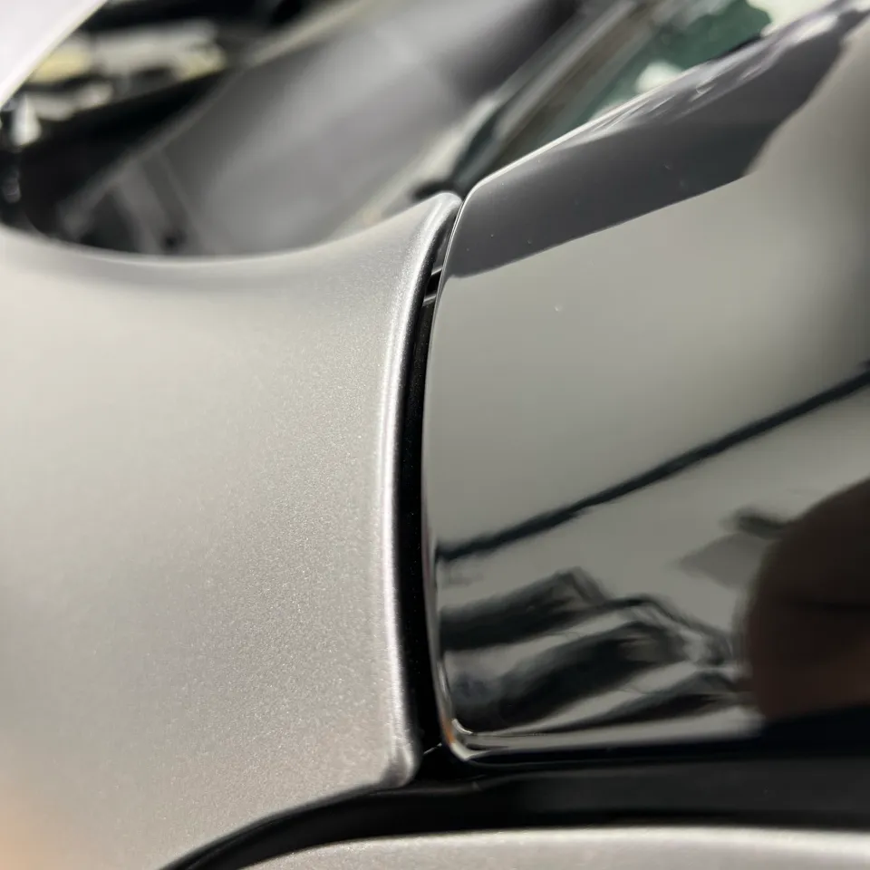 Close view of silver wrapped panel edges meeting black trim
